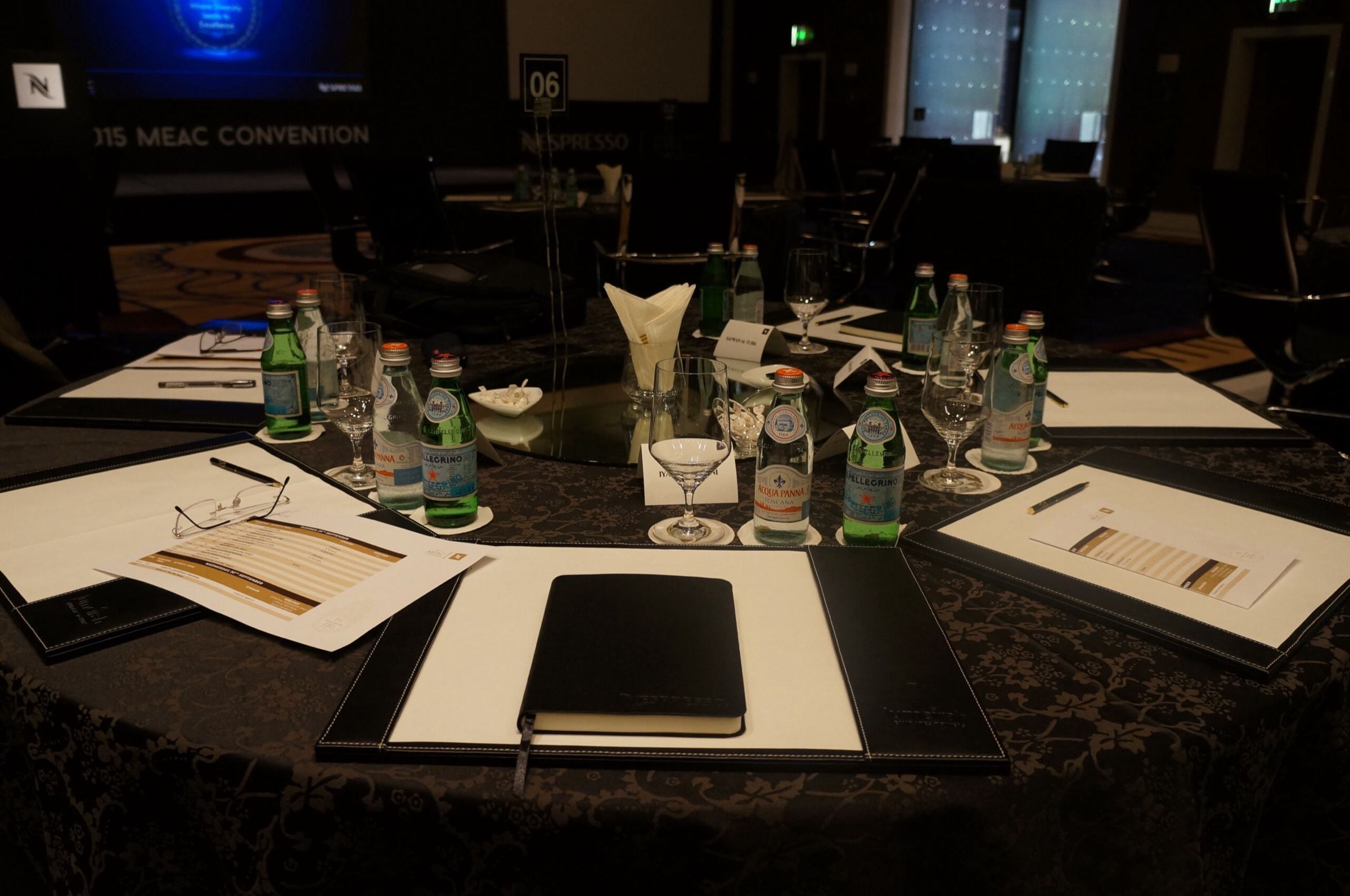 Table set with notepads and water glasses for a business meeting