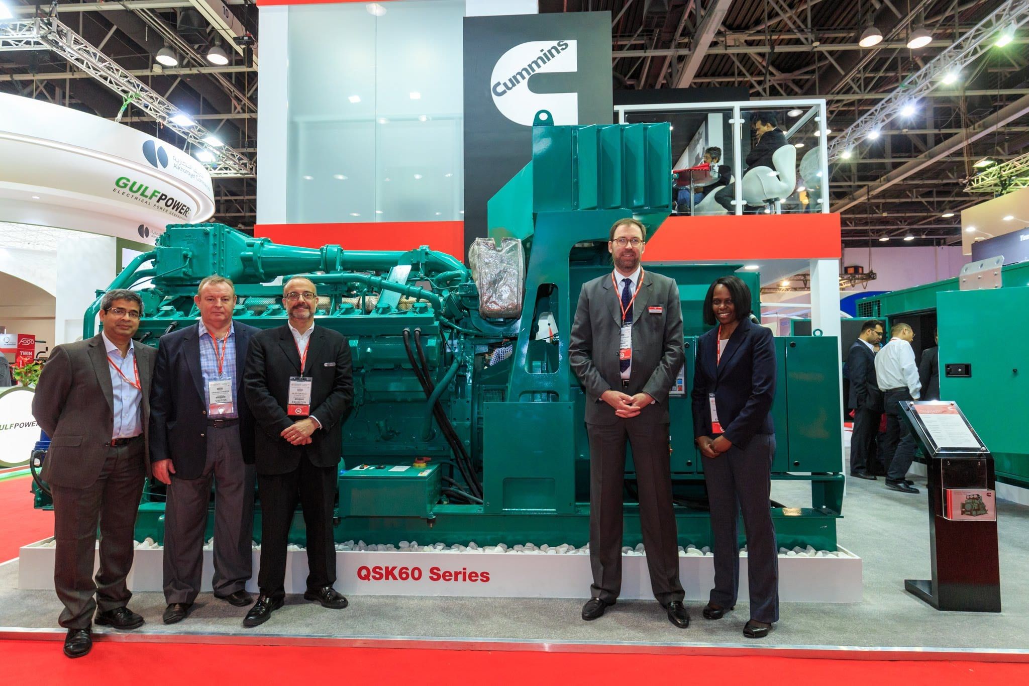 Cummins team with a QSK60 series generator on the stand