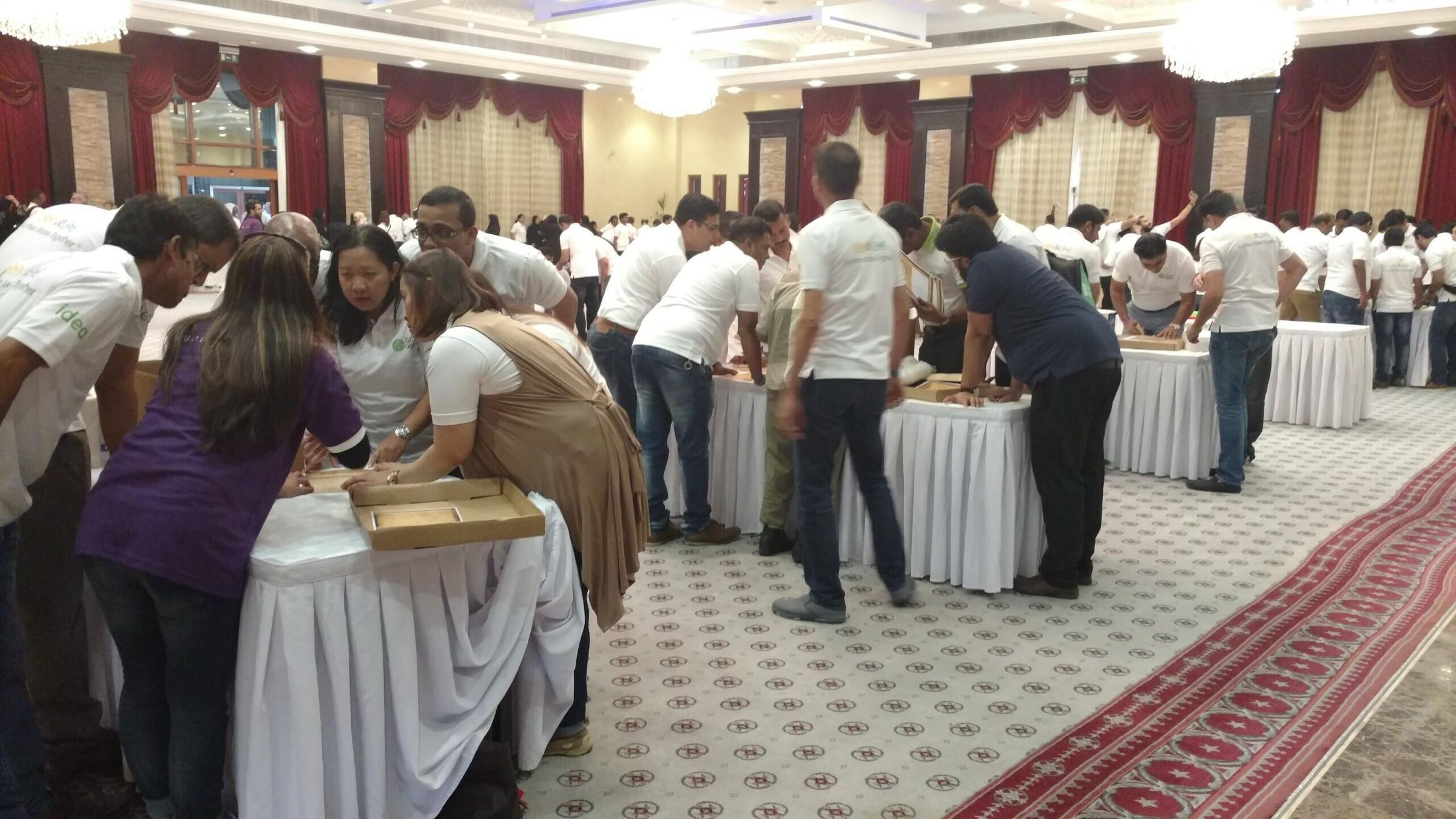 Team members working together at tables during a team-building activity