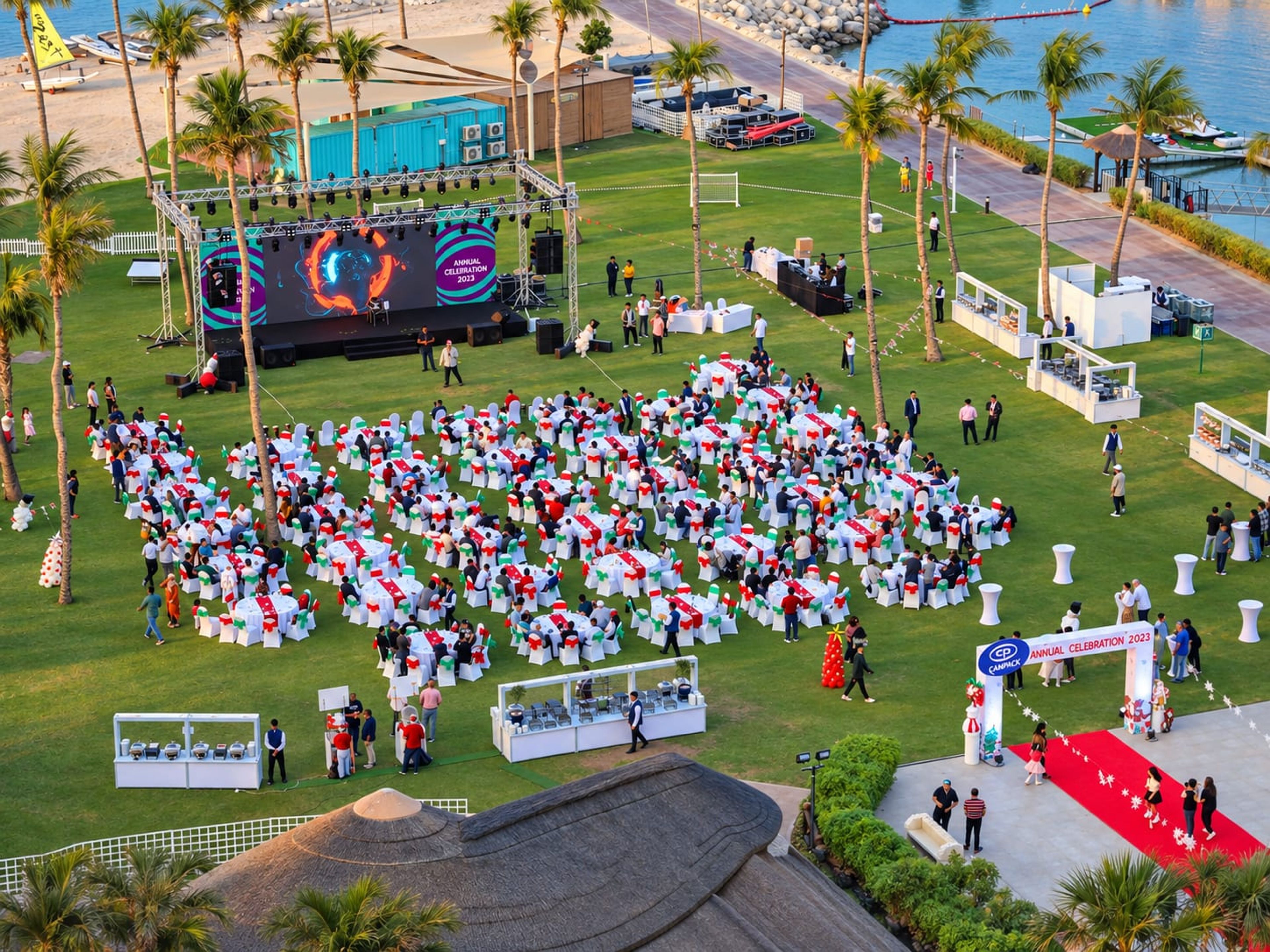 Aerial view of the CANPACK Christmas family day at JA Resort Jebel Ali: LED stage, lawn seating and red carpet