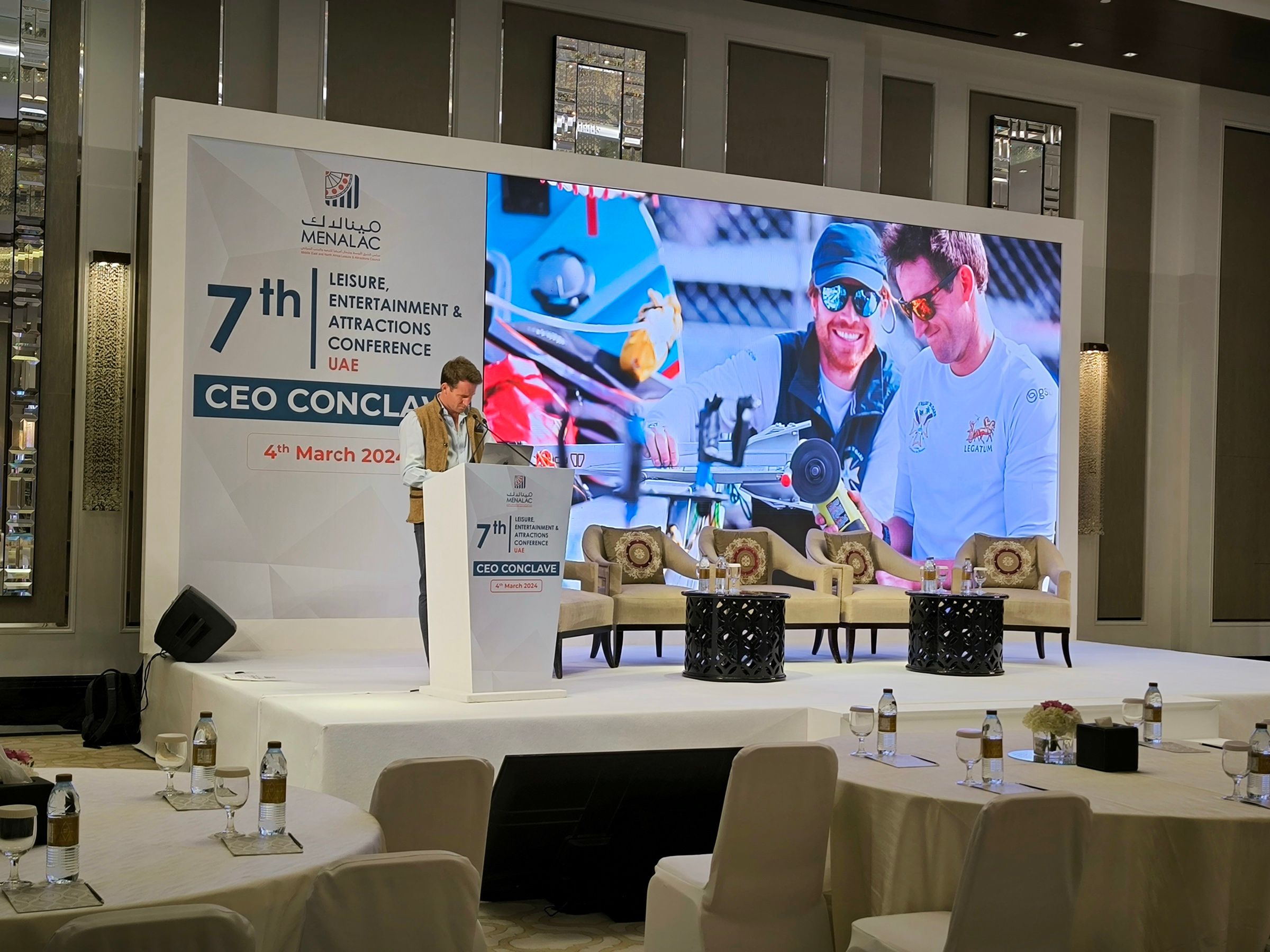 Menalac Conference stage featuring eco-friendly backdrops, podium, and seating with sustainable materials, highlighting a commitment to green practices