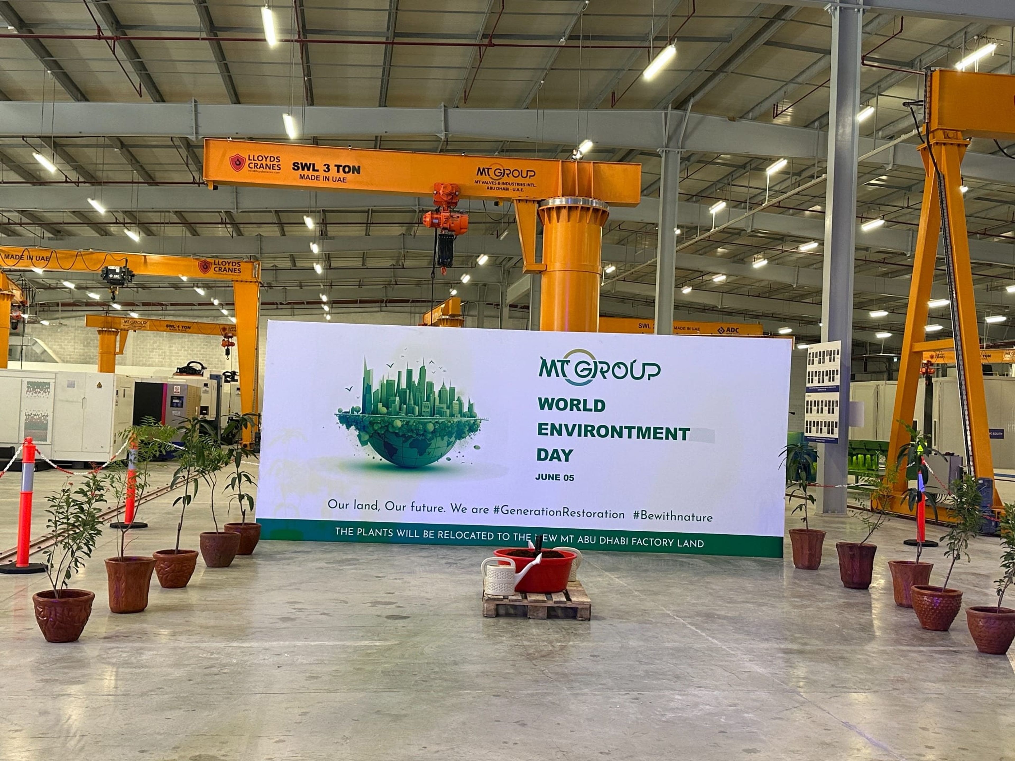 MT Group World Environment Day banner and plant display on the factory floor