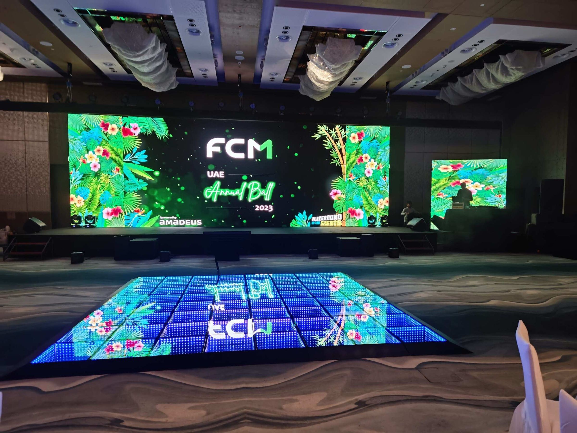LED floor and screens with bold graphics at a brand event stage