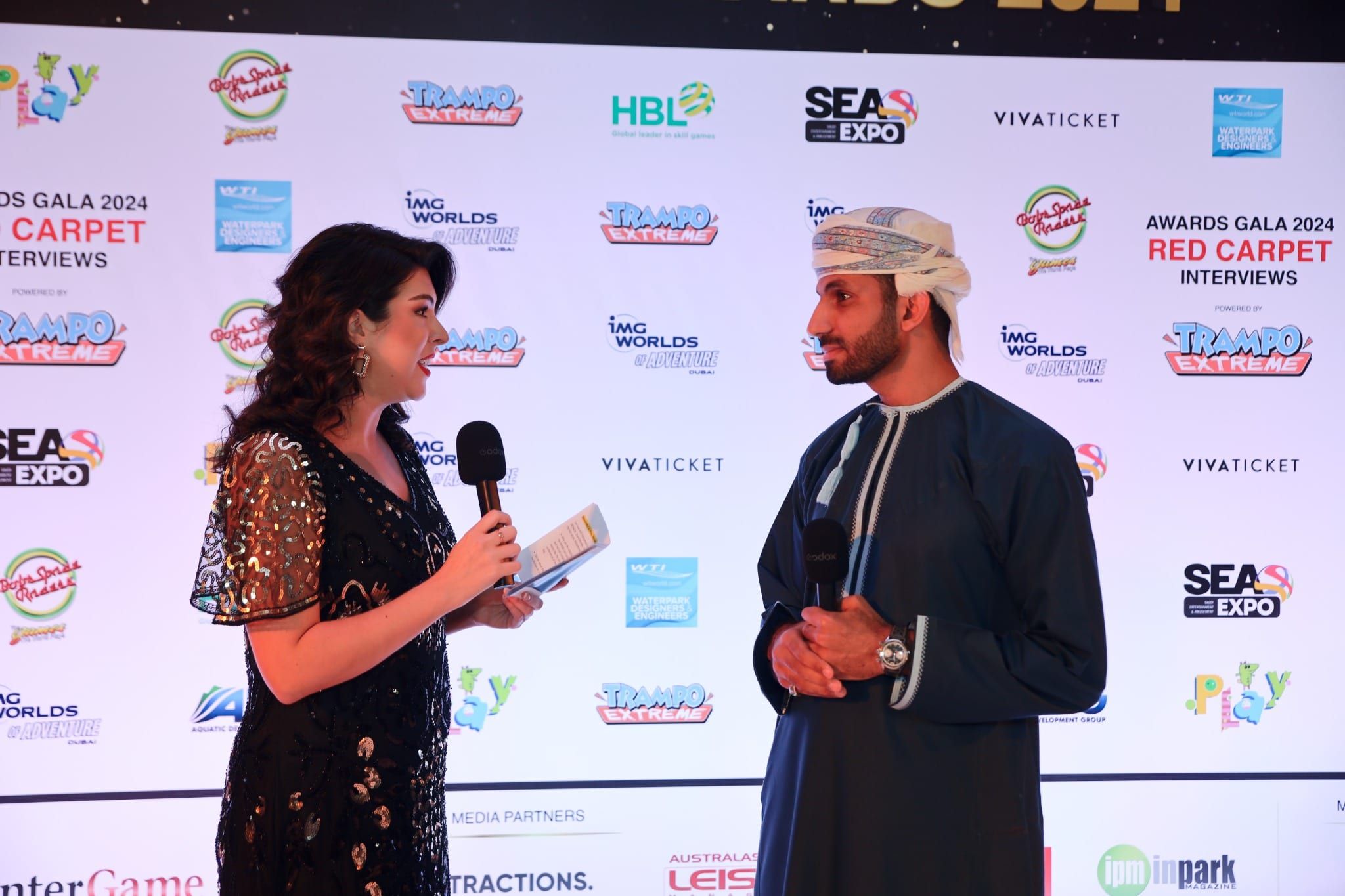 Red carpet interview in front of the MENALAC Awards 2024 media wall