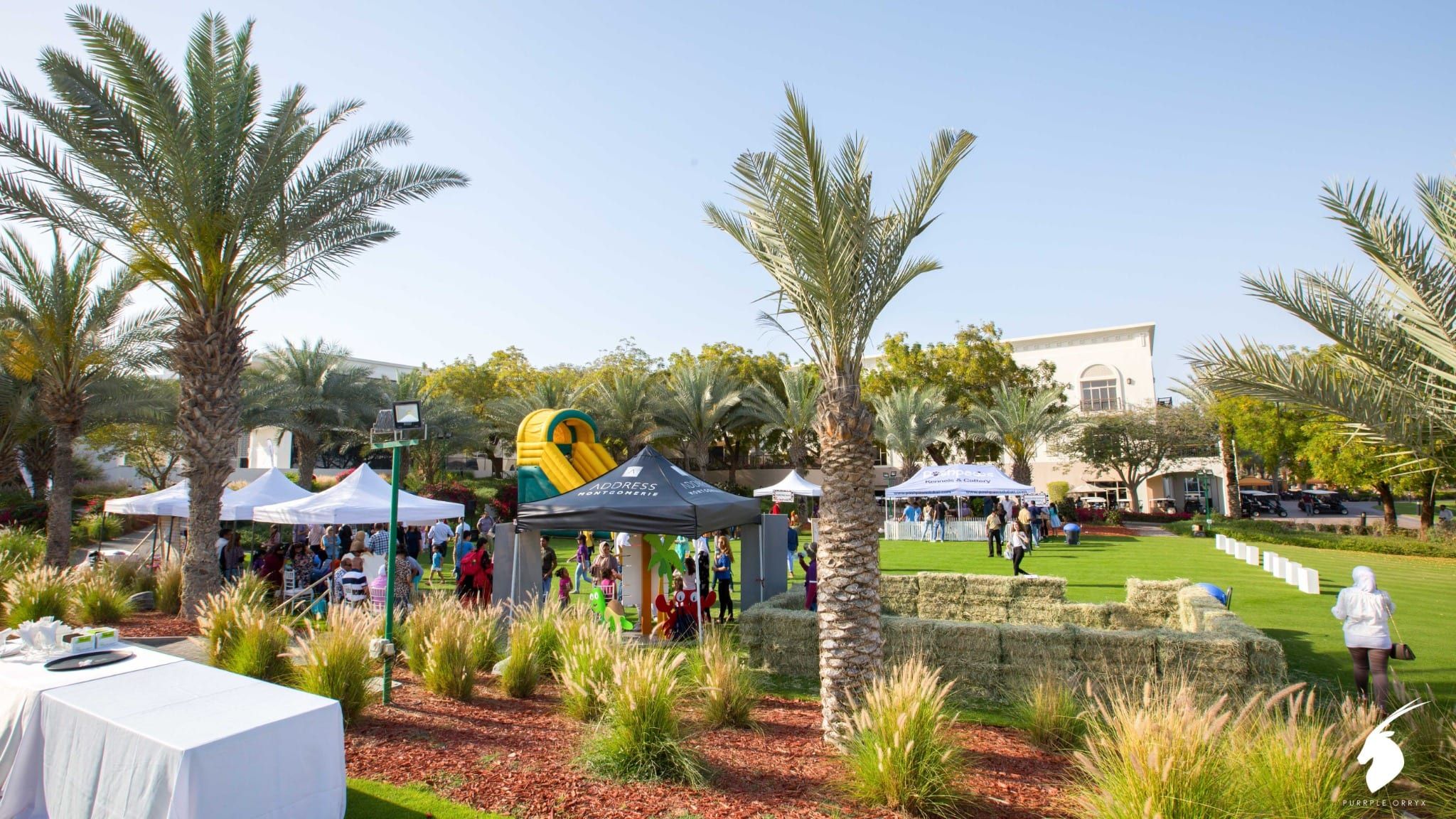 Family day site with gazebos, a bouncy castle and landscaped garden at Address Montgomerie