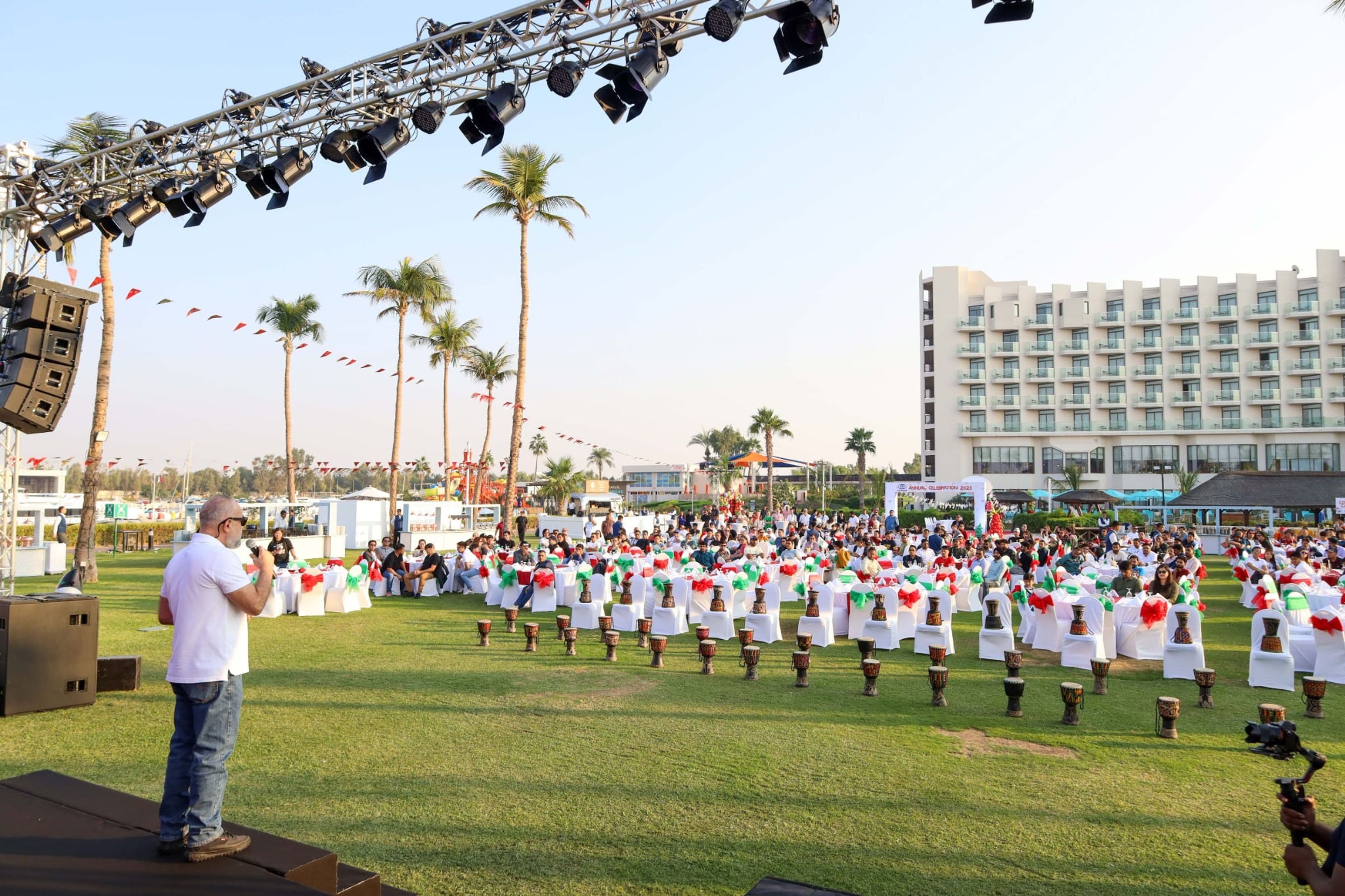 Host leading an outdoor group activity on the lawn at JA Resort Jebel Ali