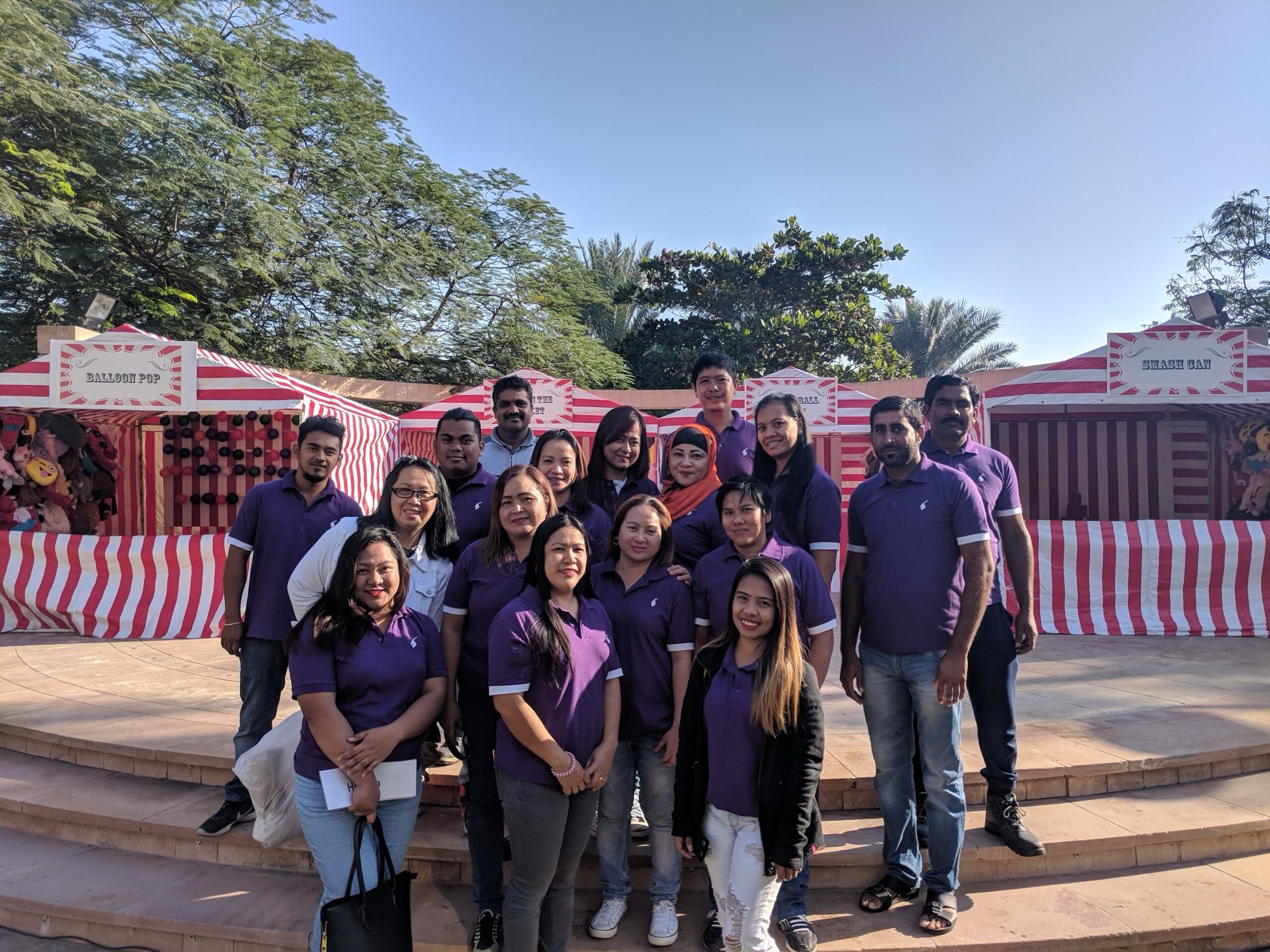 Event team in matching purple shirts at an outdoor venue