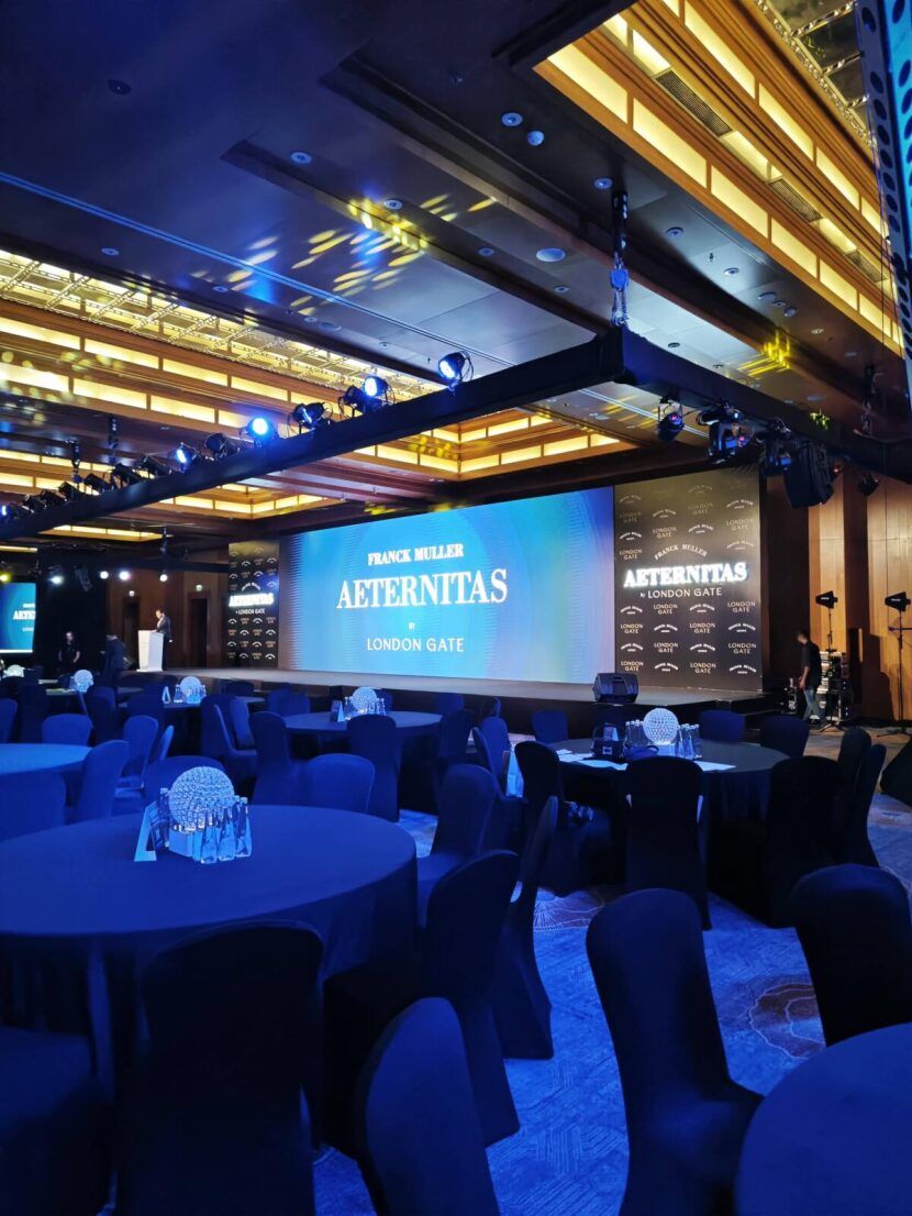 Stage with a large LED screen and blue lighting for a product launch