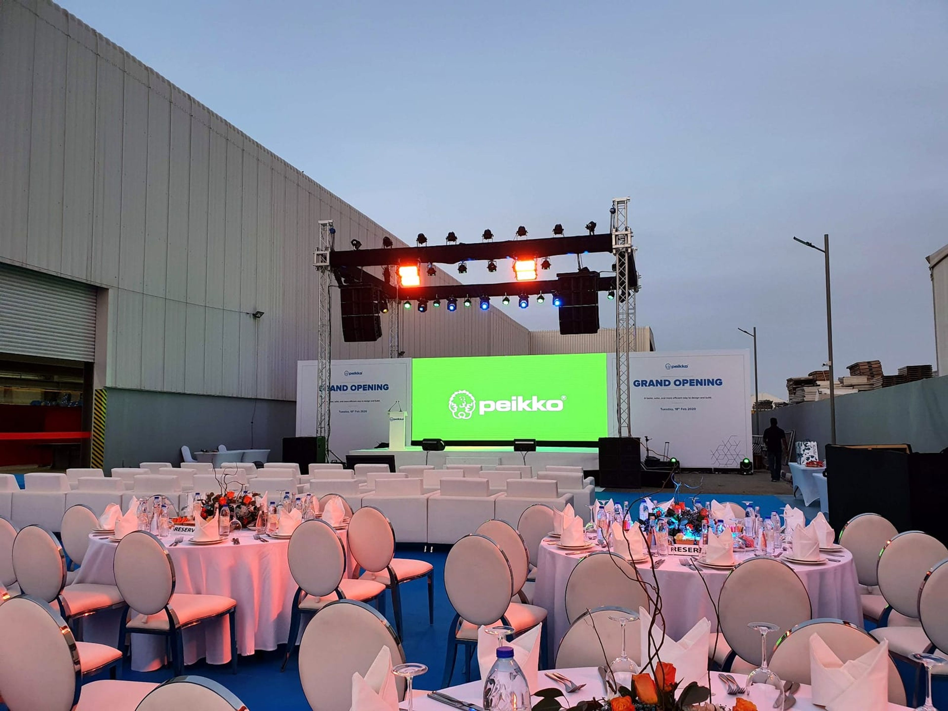 Outdoor stage, truss lighting and round tables at the Peikko Gulf facility grand opening, Ras Al Khaimah