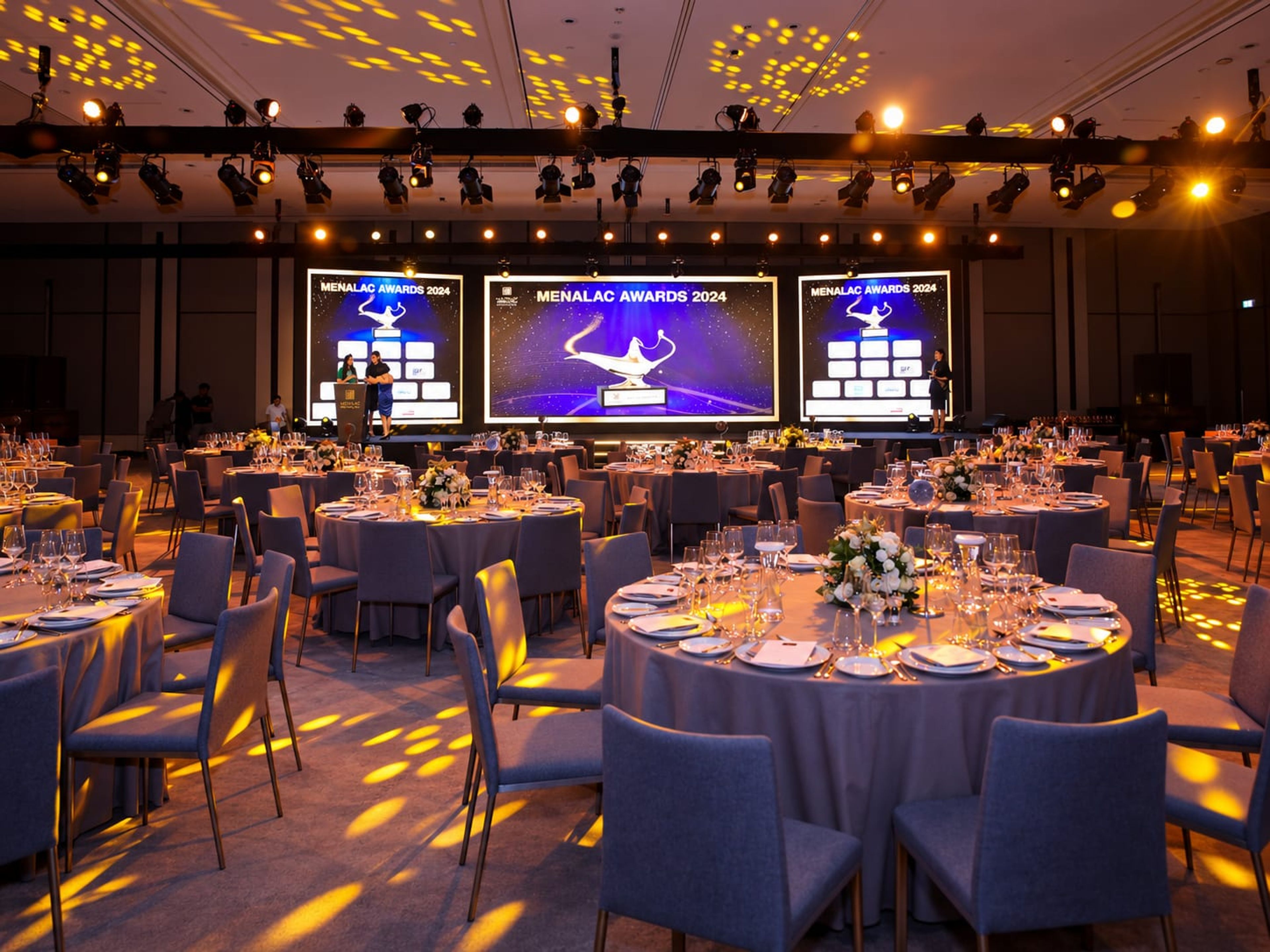 MENALAC Awards 2024 gala ballroom with round tables and LED screens at Sky View Dubai