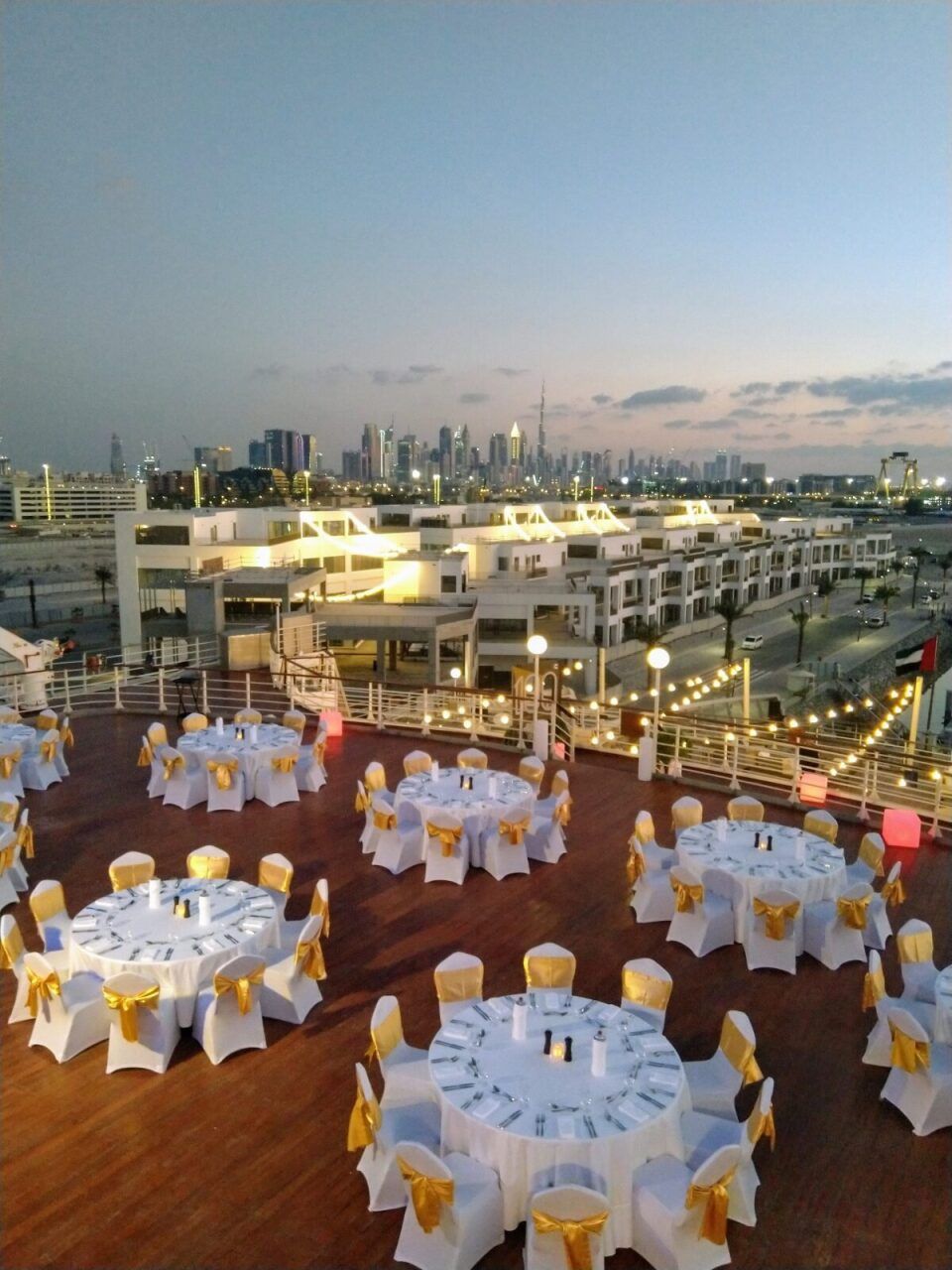 Rooftop dinner setup overlooking the Dubai skyline at dusk
