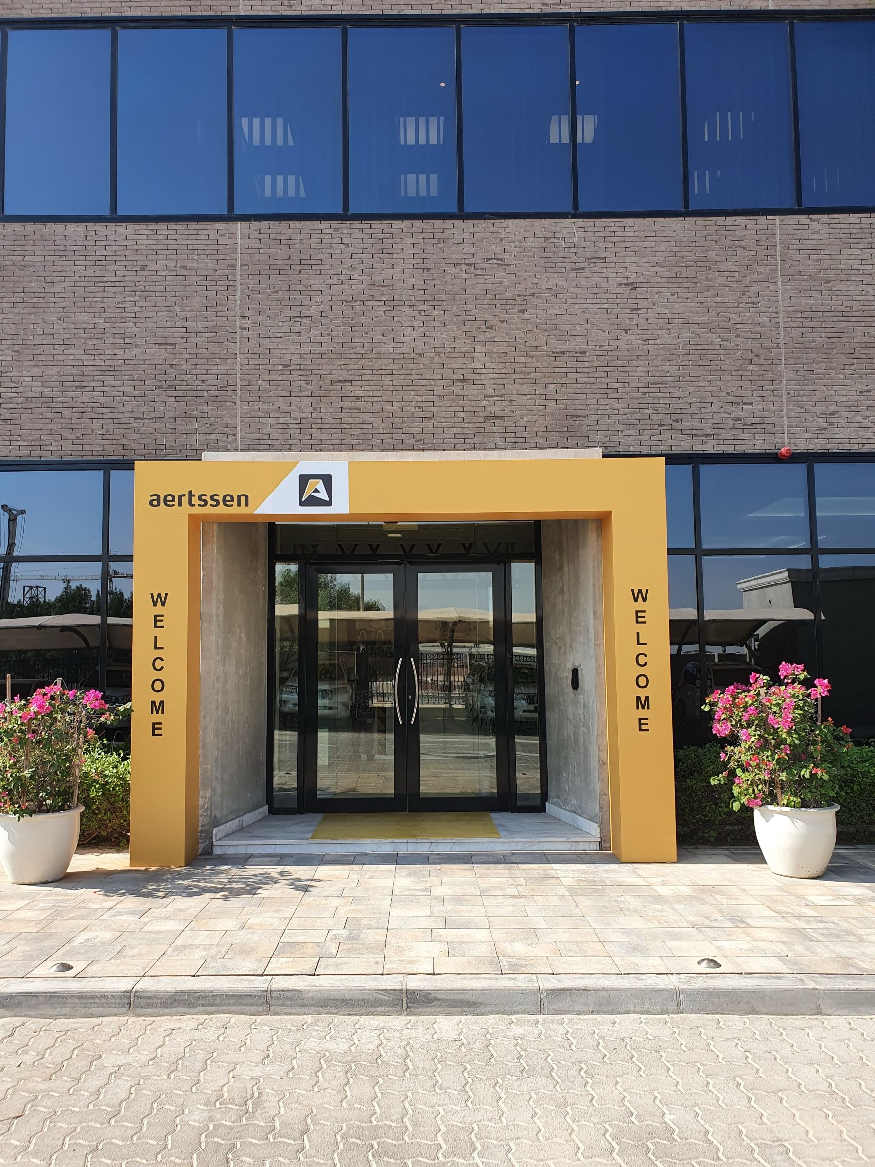 Branded entrance to a corporate facility decorated for an opening event