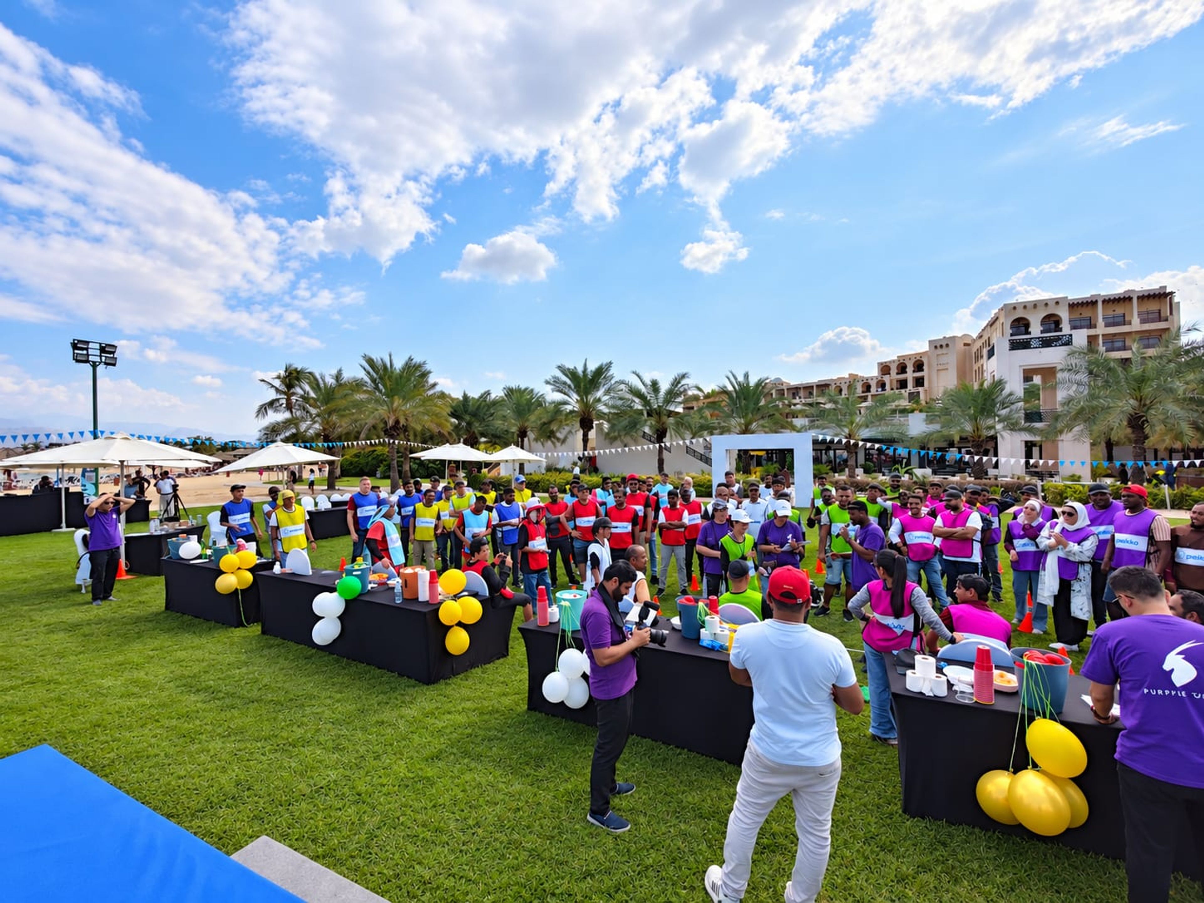 Teams competing at table challenge stations on the lawn at Hilton Ras Al Khaimah