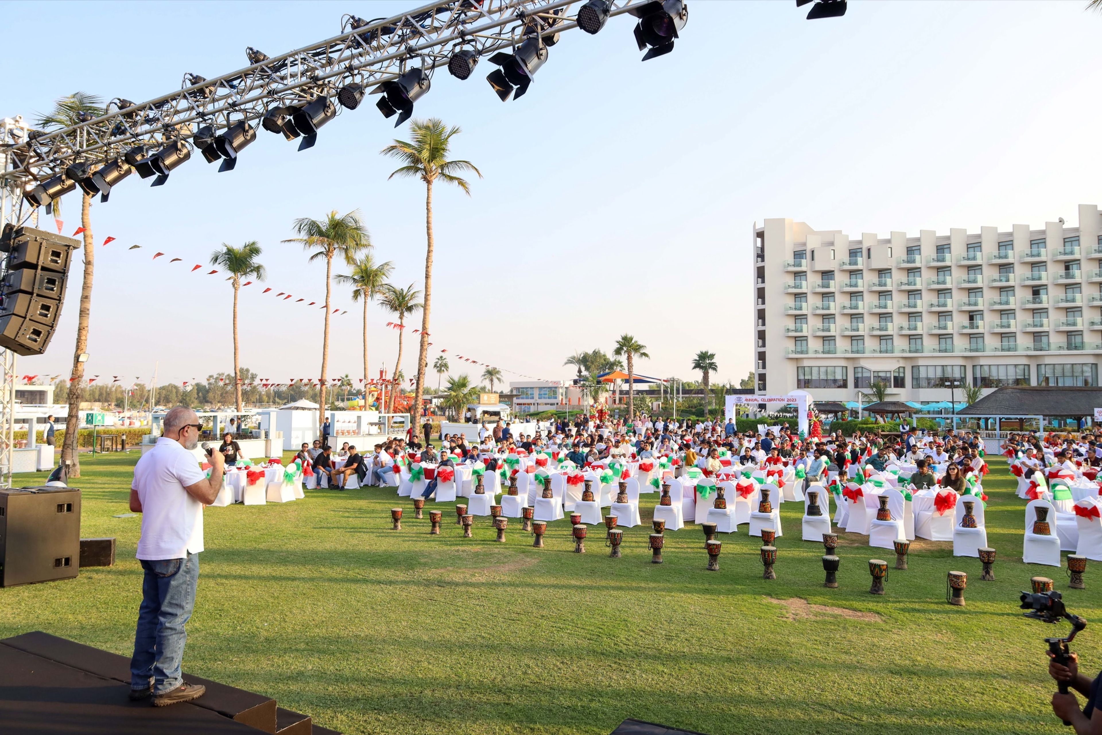 Marching band performing on a lawn at an outdoor corporate event