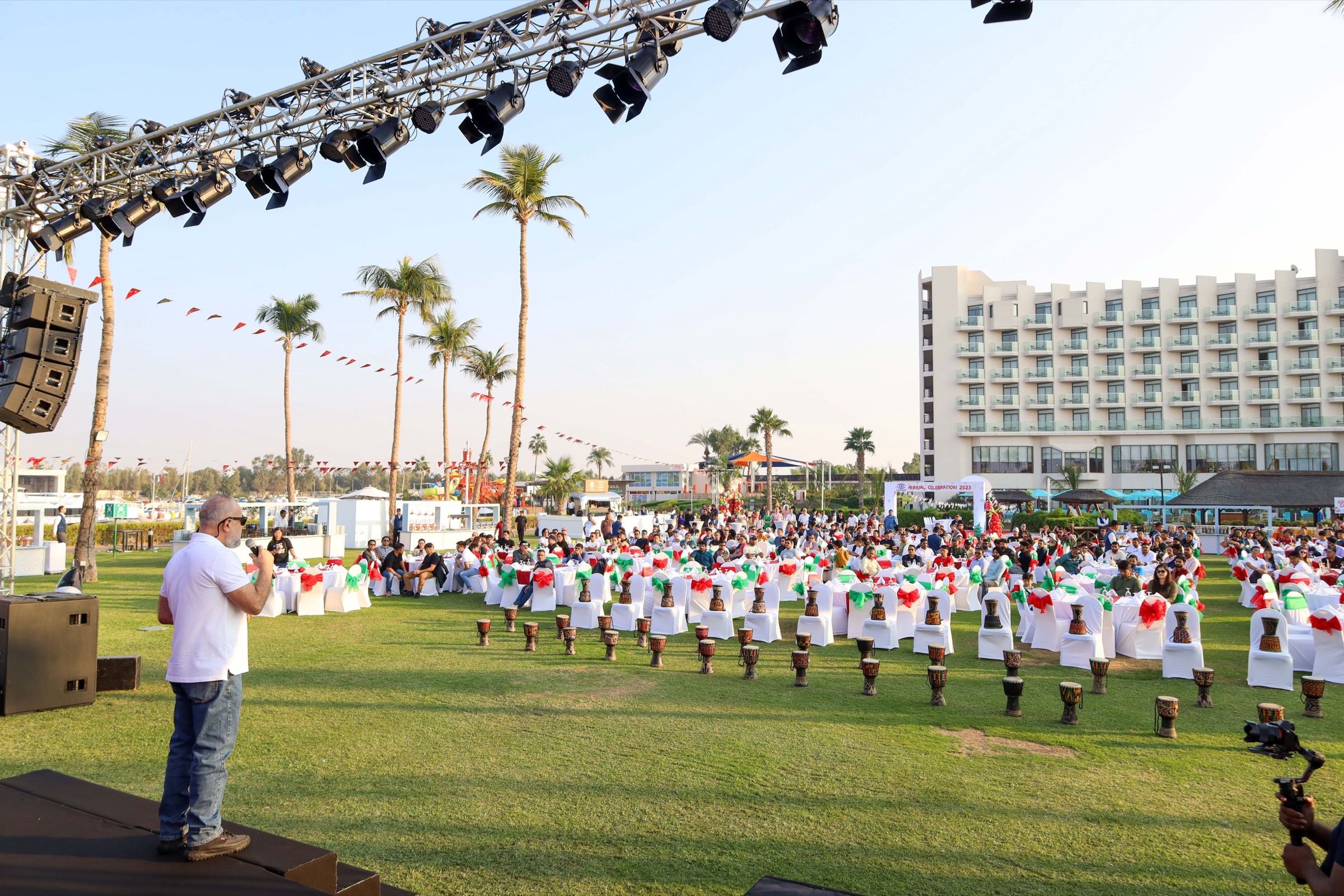 Marching band performing on a lawn at an outdoor corporate event