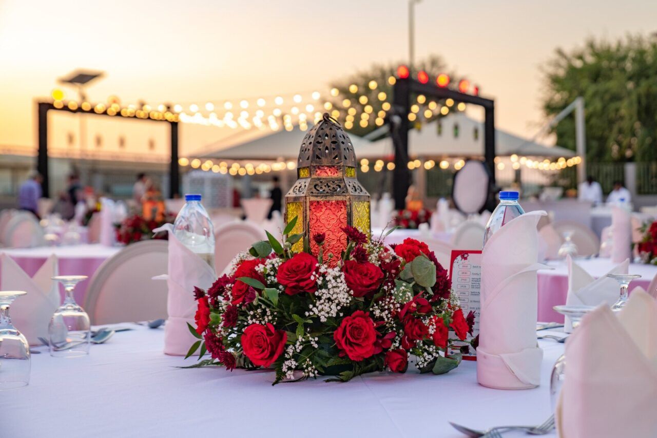 Ramadan table setting with a lantern centrepiece and red roses