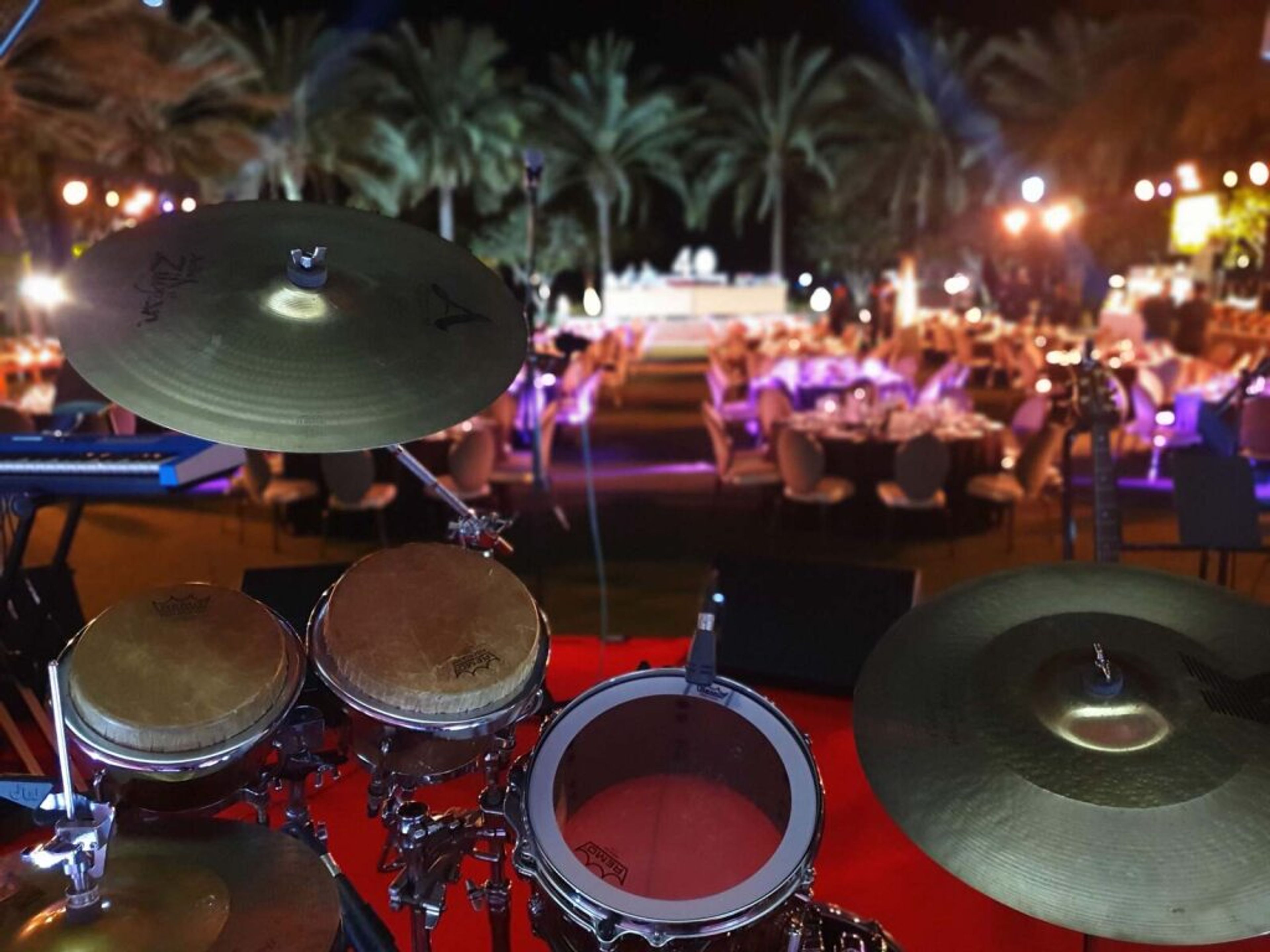 Drum kit on stage at an outdoor evening event