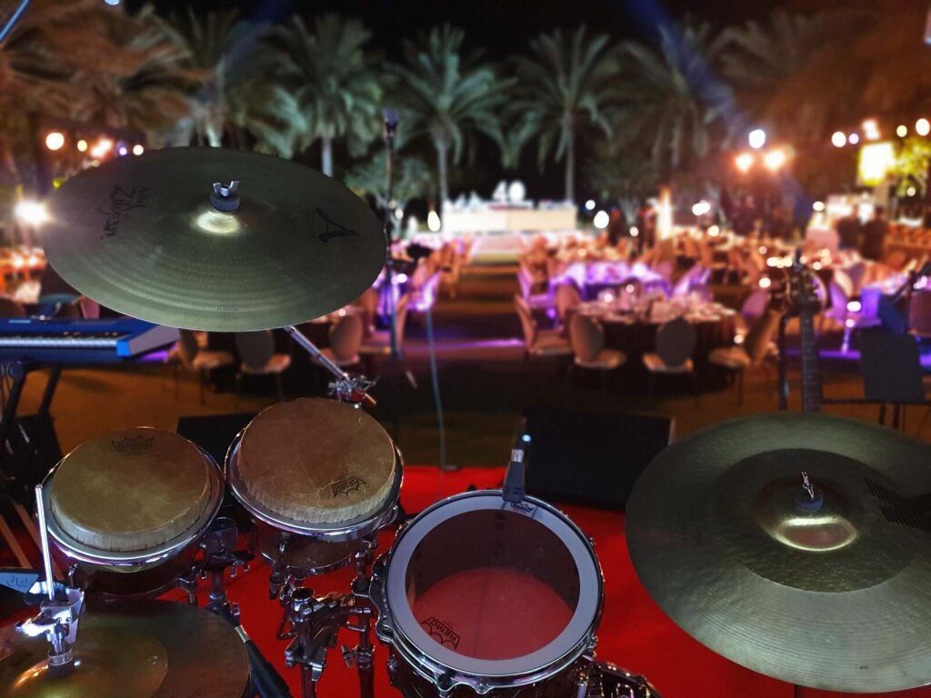 Drum kit on stage at an outdoor evening event
