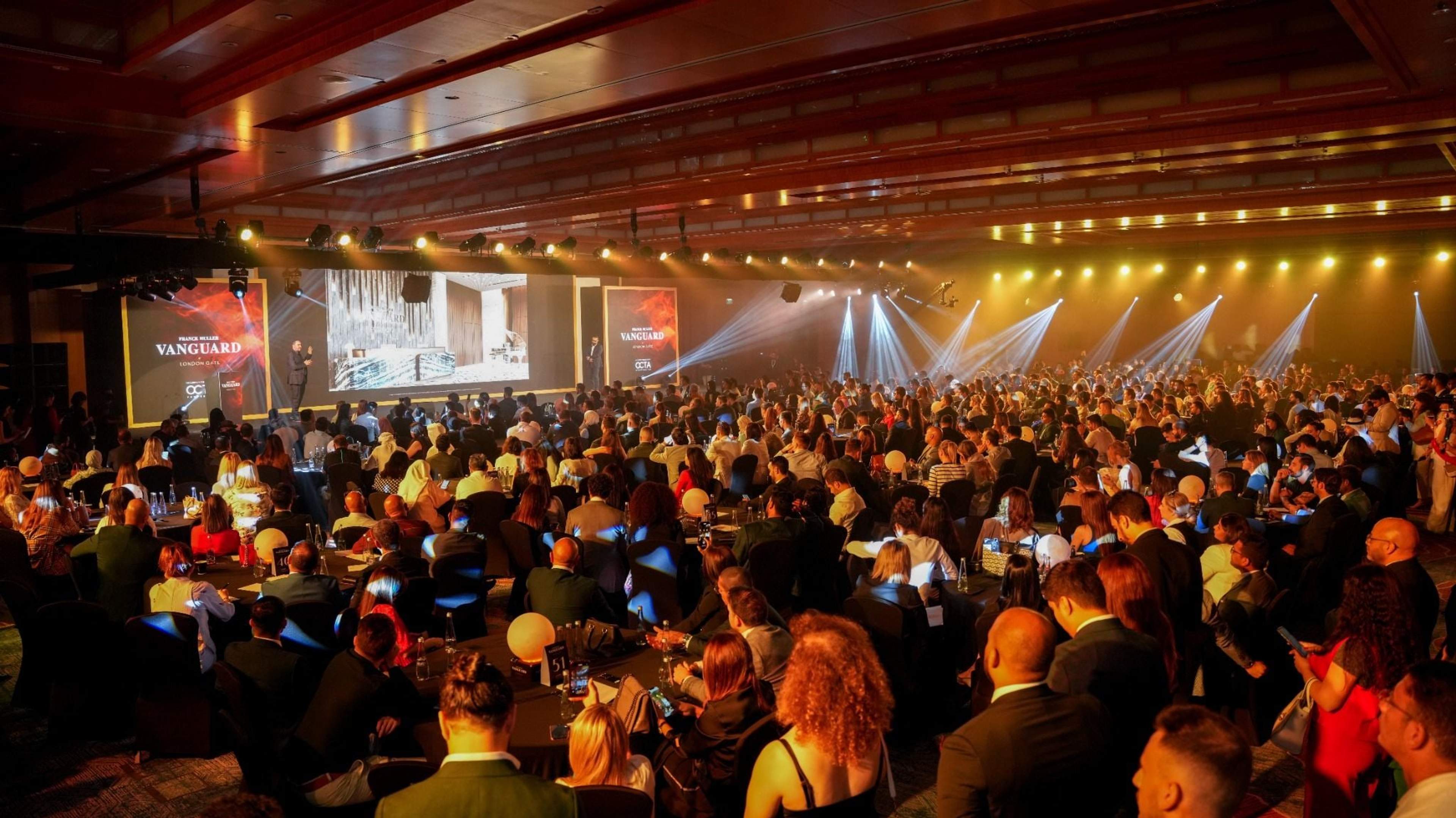 Full ballroom of guests under warm stage lighting at the Franck Muller Vanguard launch, The Ritz-Carlton DIFC