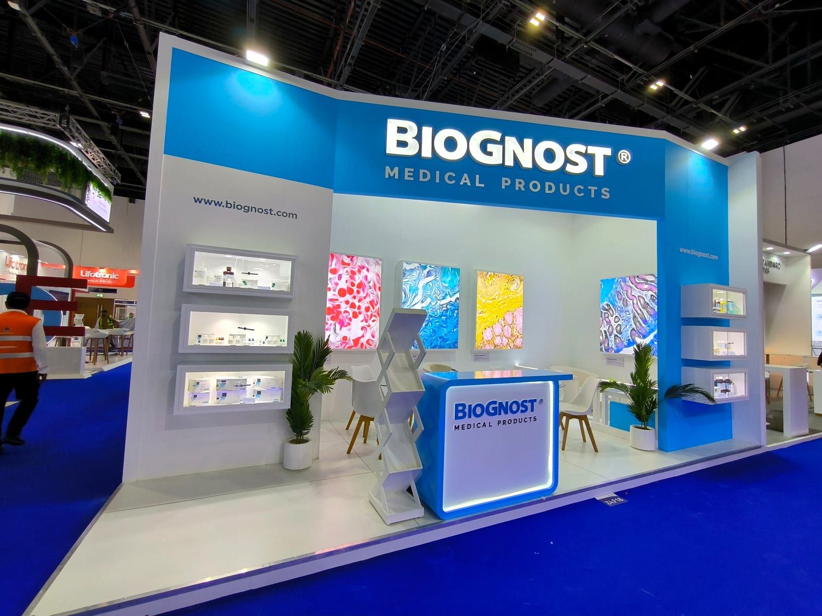 Biognost Medical Products exhibition stand with backlit displays and branded counter at Medlab Dubai