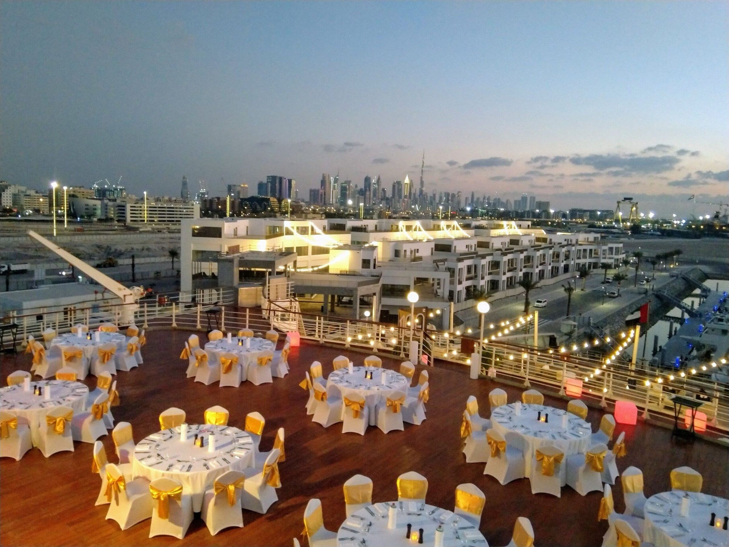 Rooftop dinner setup overlooking the Dubai skyline at sunset