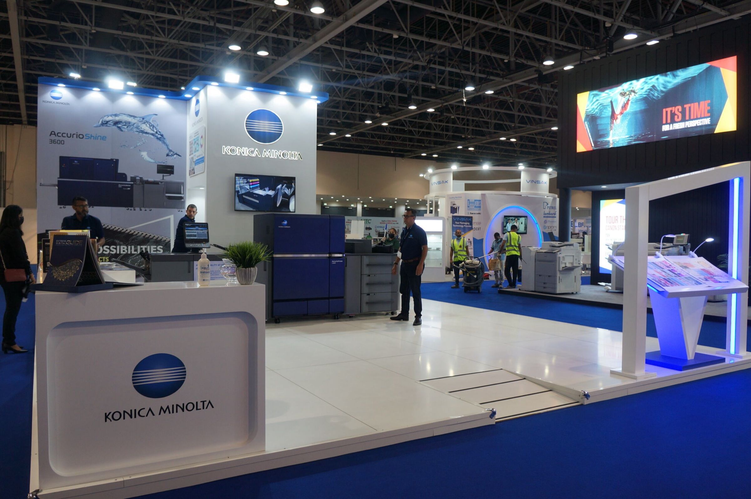 Exhibition stand with printers on display and branded overhead signage