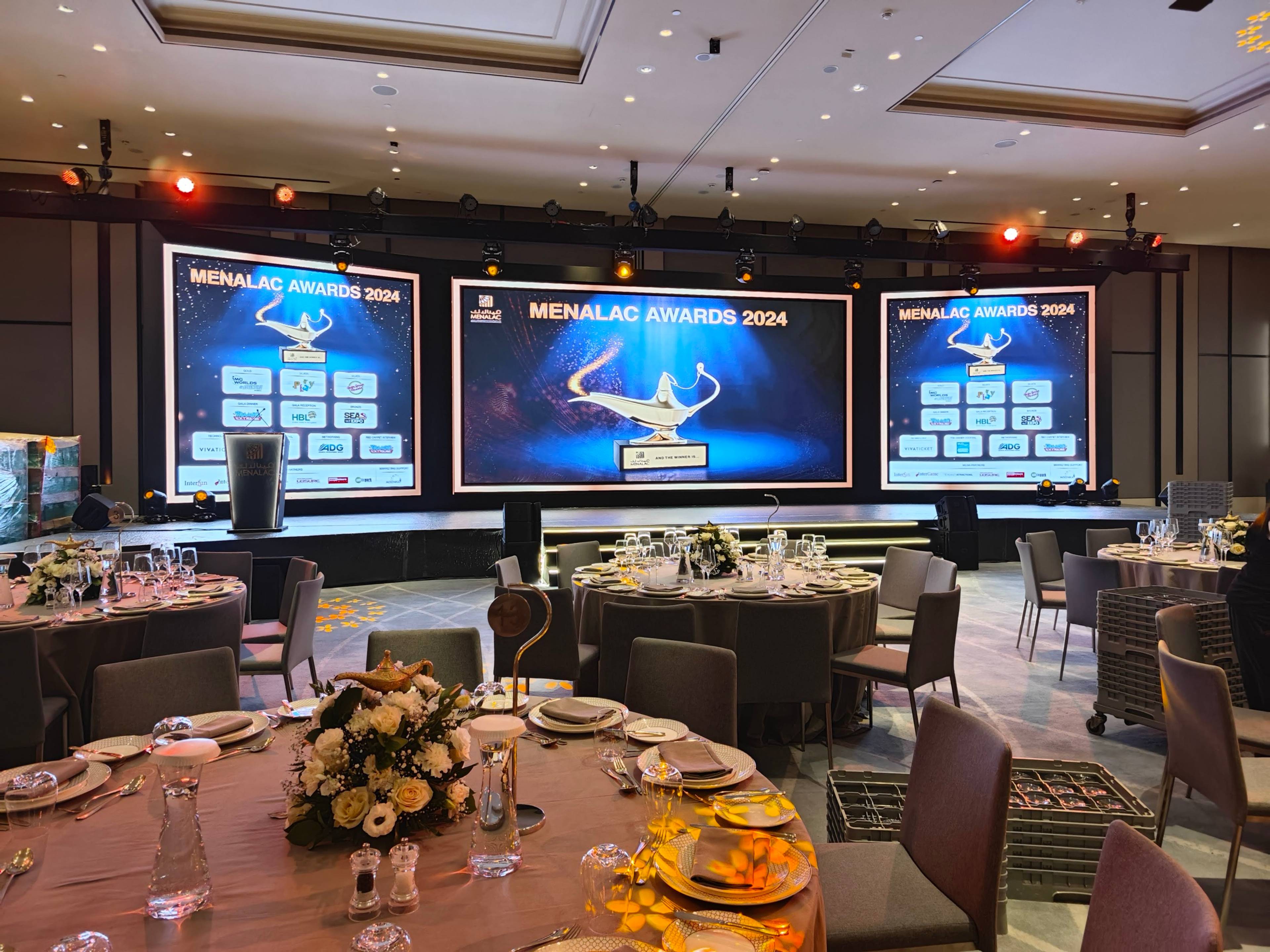 Indoor award ceremony setup with decorative lighting and audience seating