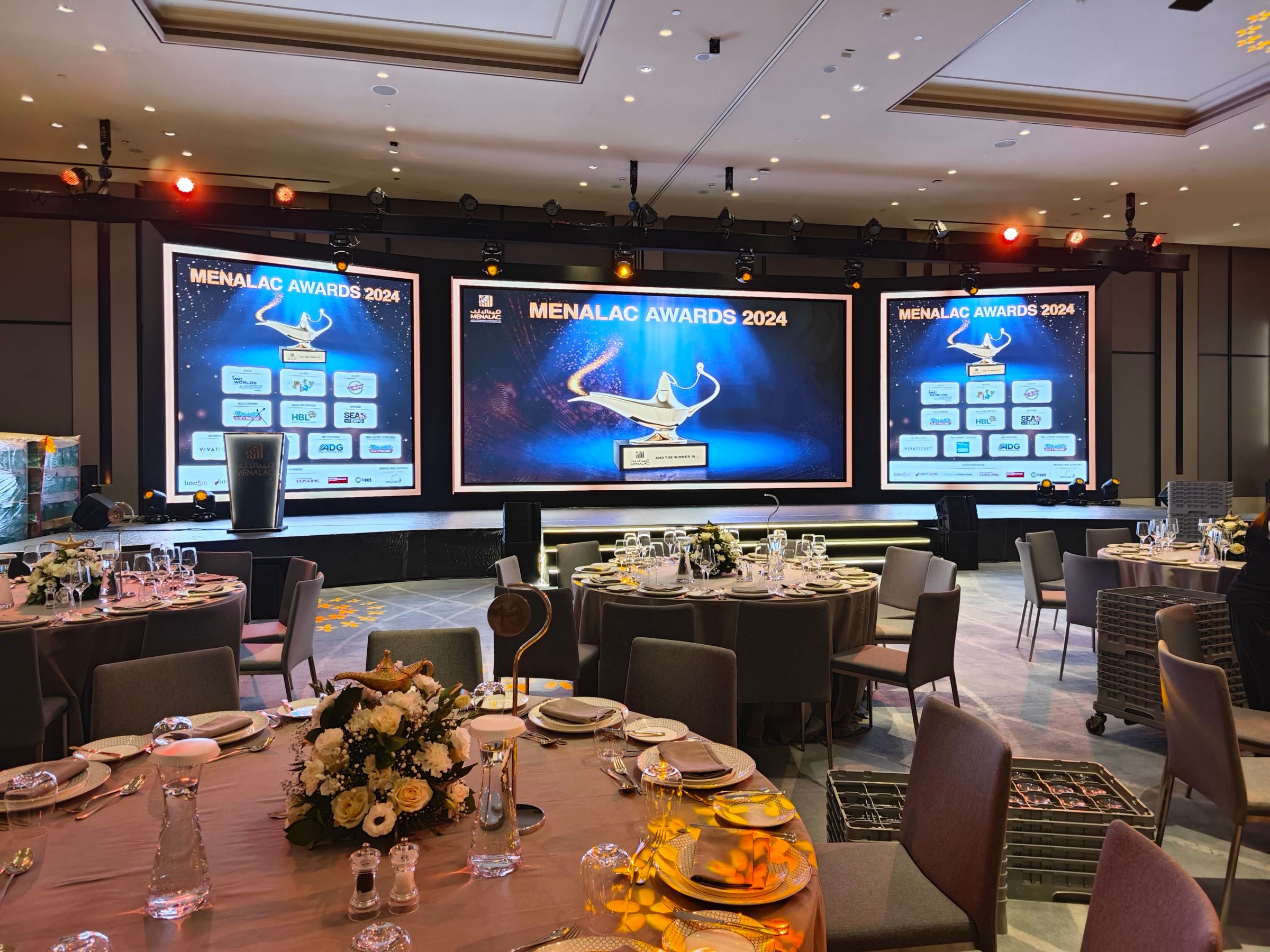 Indoor award ceremony setup with decorative lighting and audience seating.