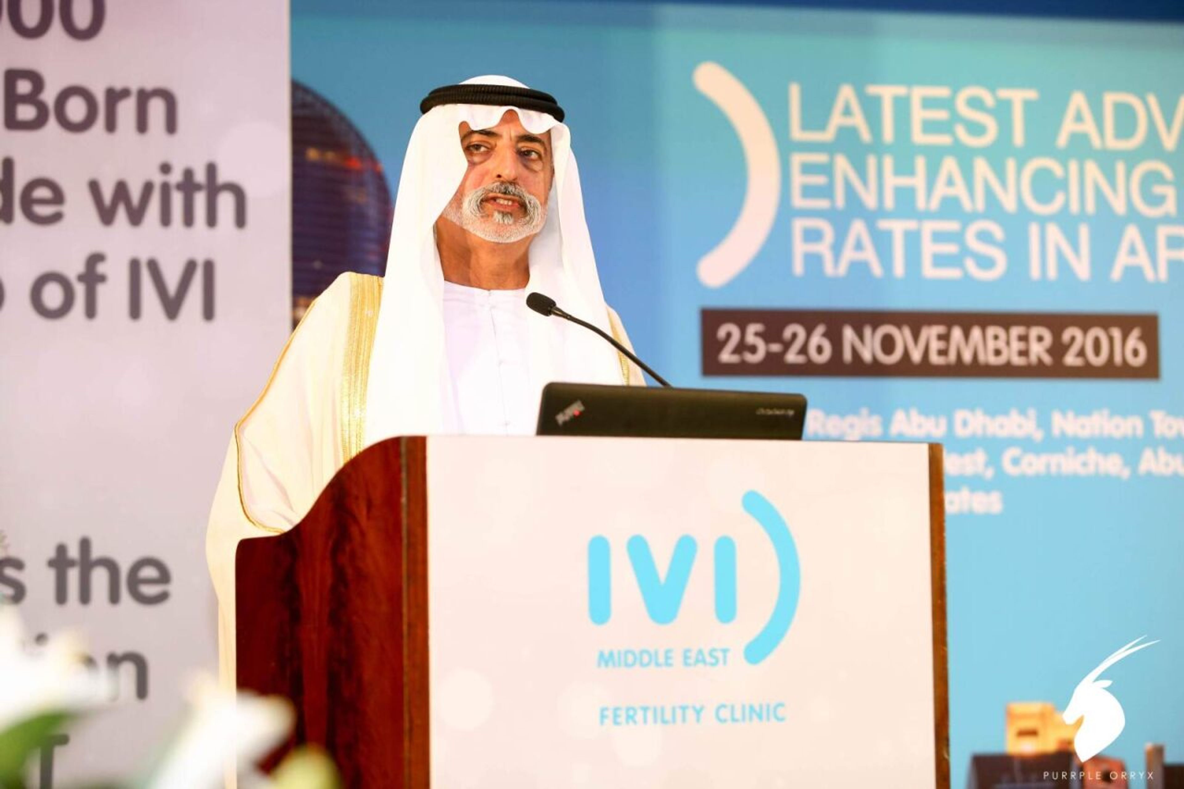 Speaker delivering a keynote at a medical conference podium