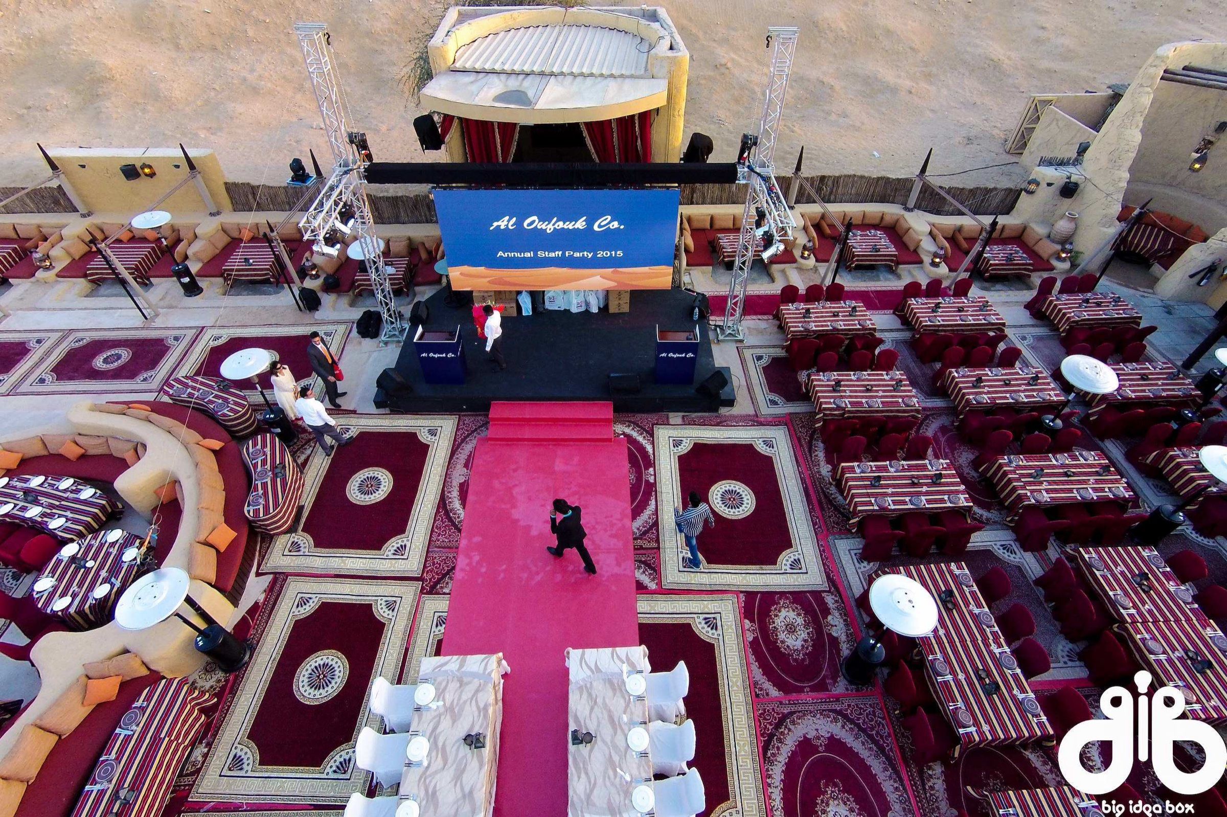 Aerial view of an Arabian-style event with carpets and majlis seating