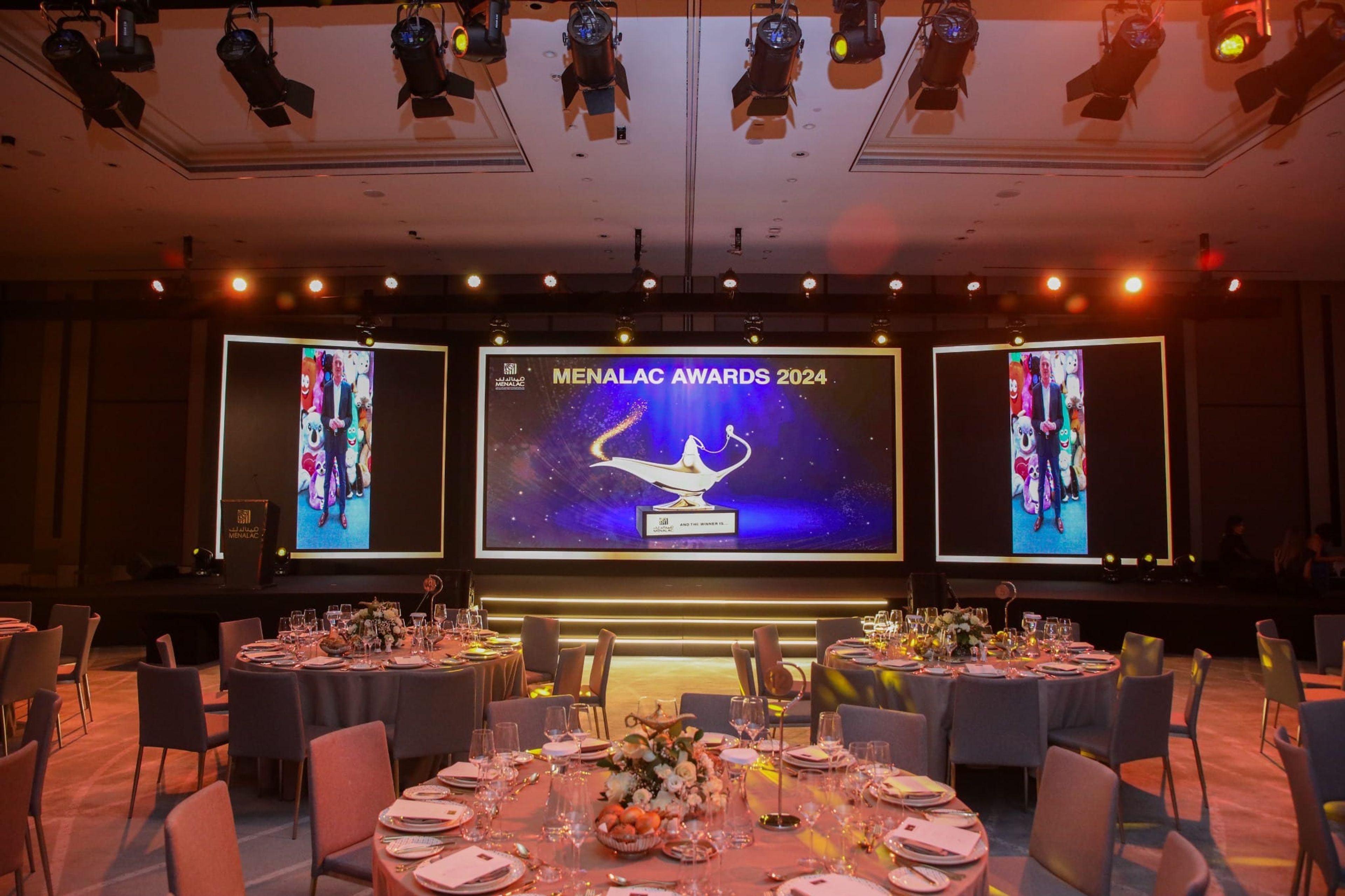 Awards stage with MENALAC Awards 2024 LED screens above the gala tables