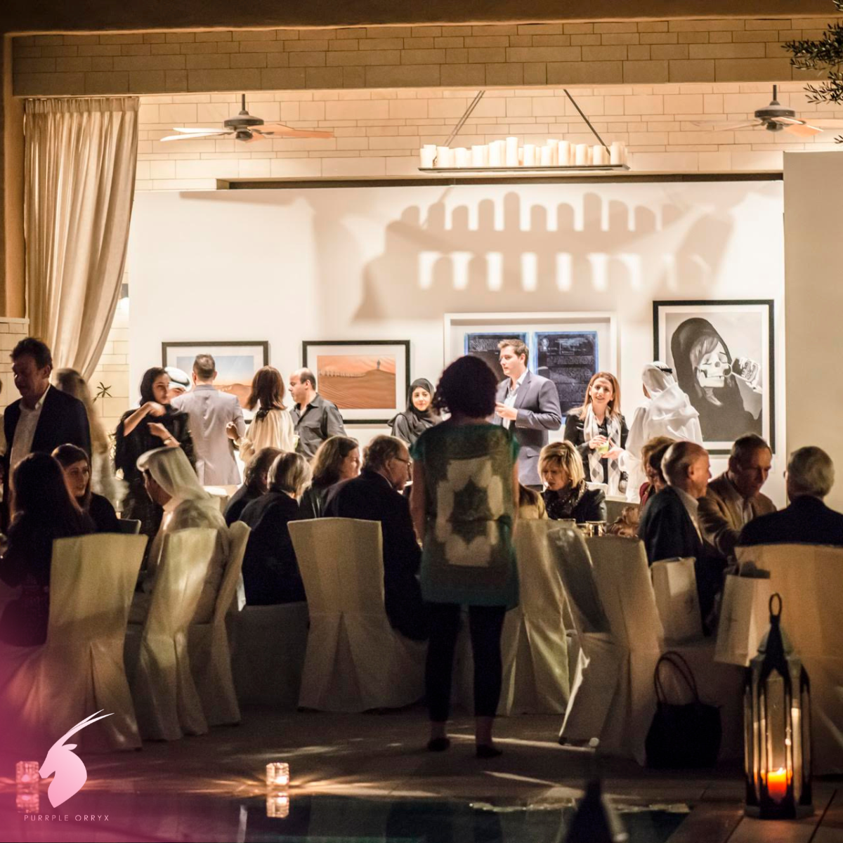 Guests seated at an art gallery event