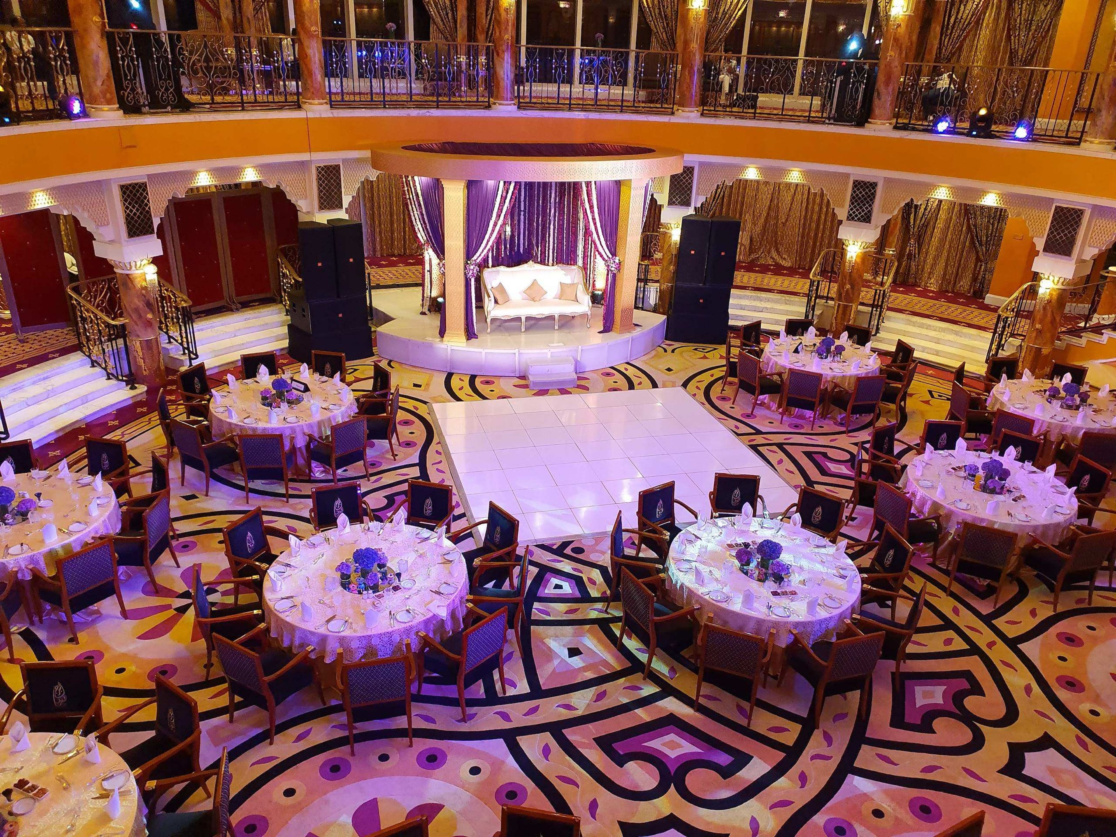 Aerial view of a ballroom gala dinner with purple lighting