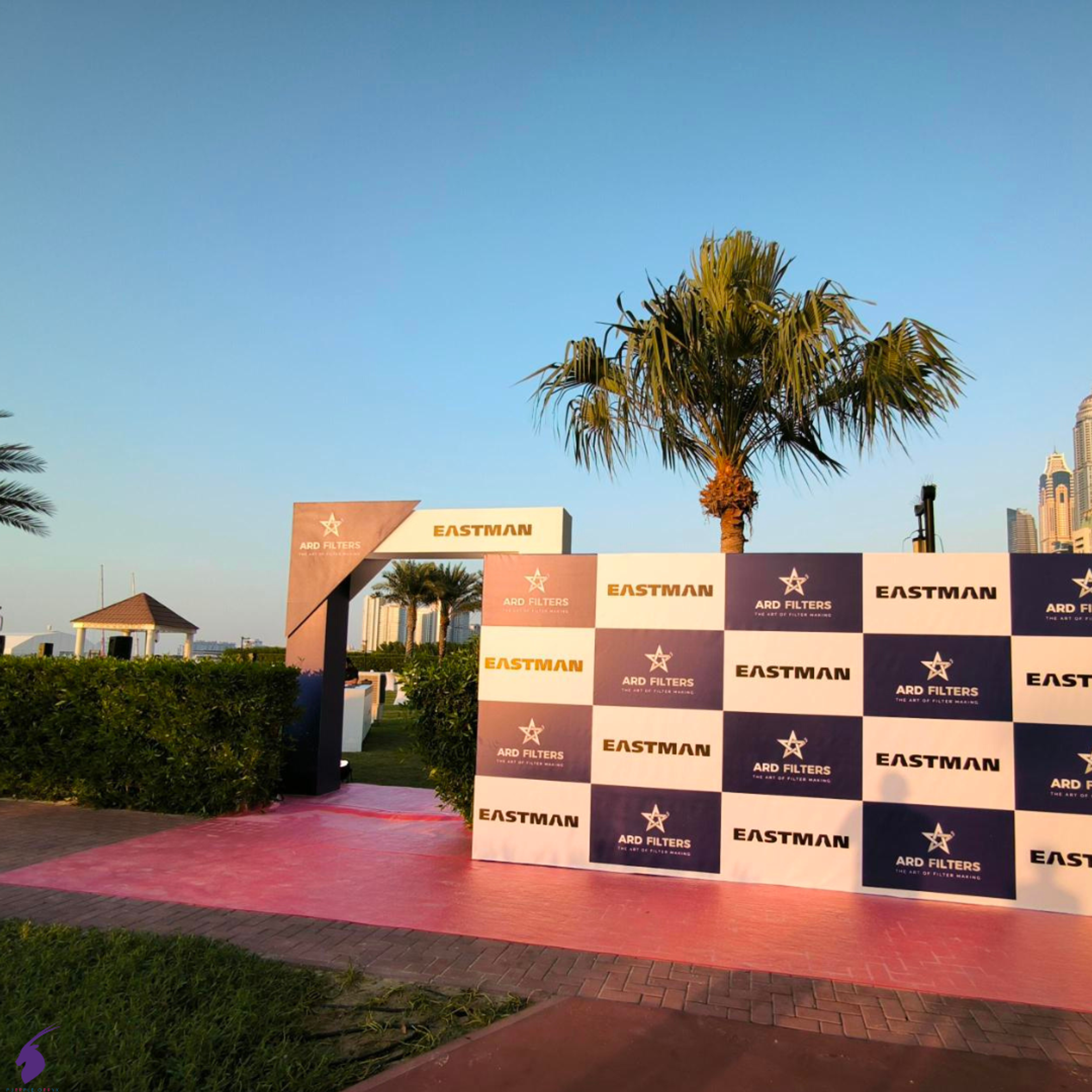 Eco-friendly media wall featuring reusable frames and repurposed banners for a sustainable corporate event."