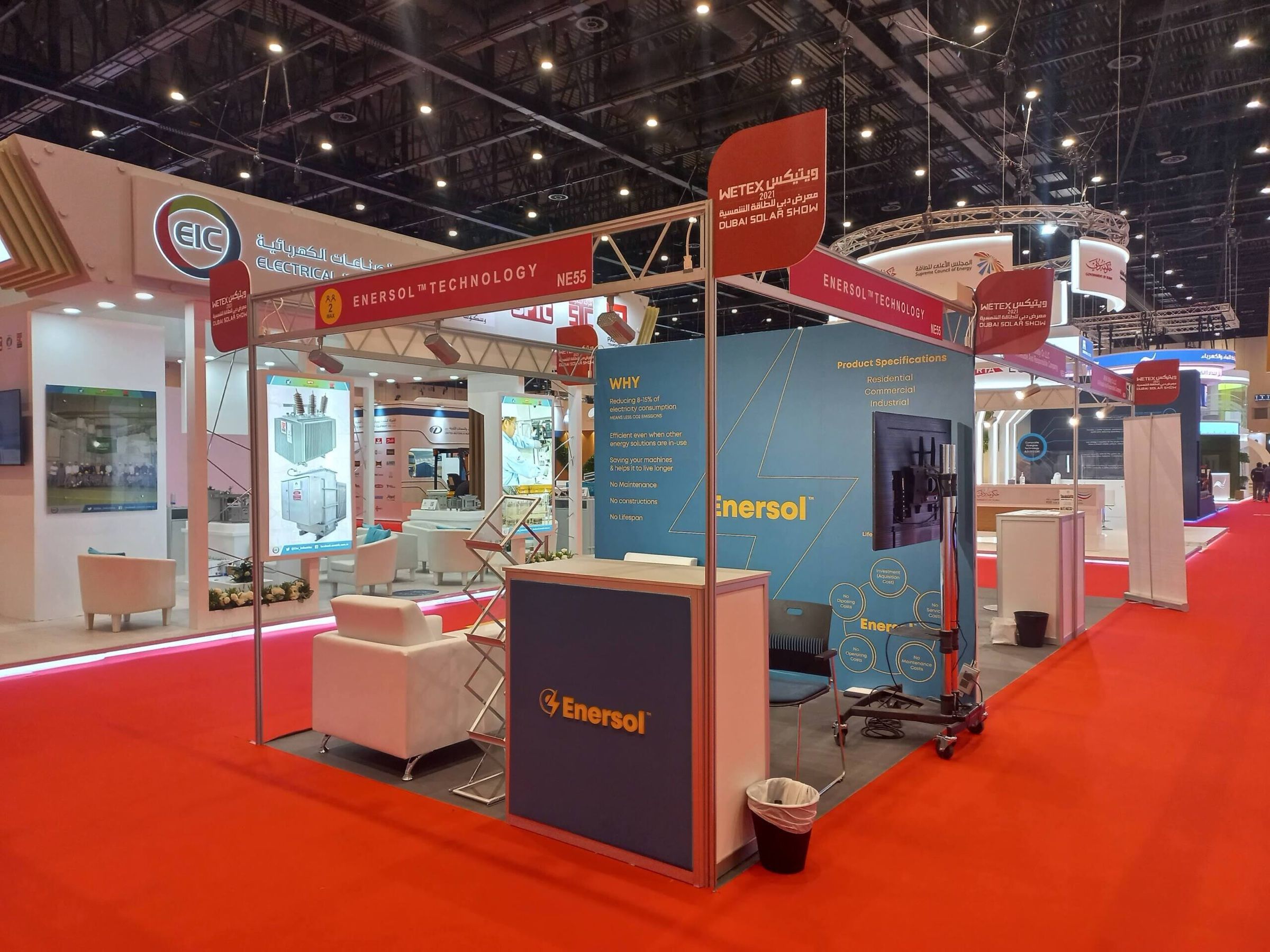 Red-floored exhibition stand with meeting counters and branded panels