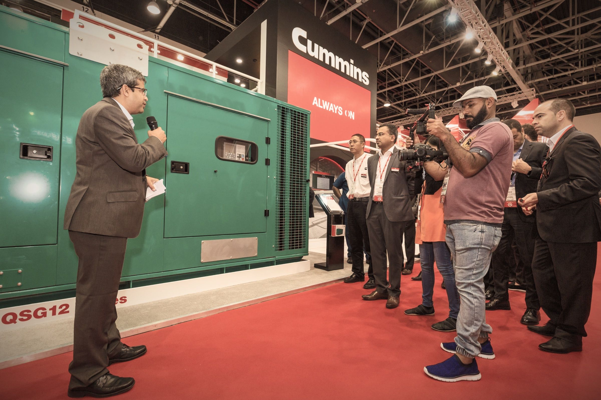 Guests viewing industrial generators at an exhibition stand