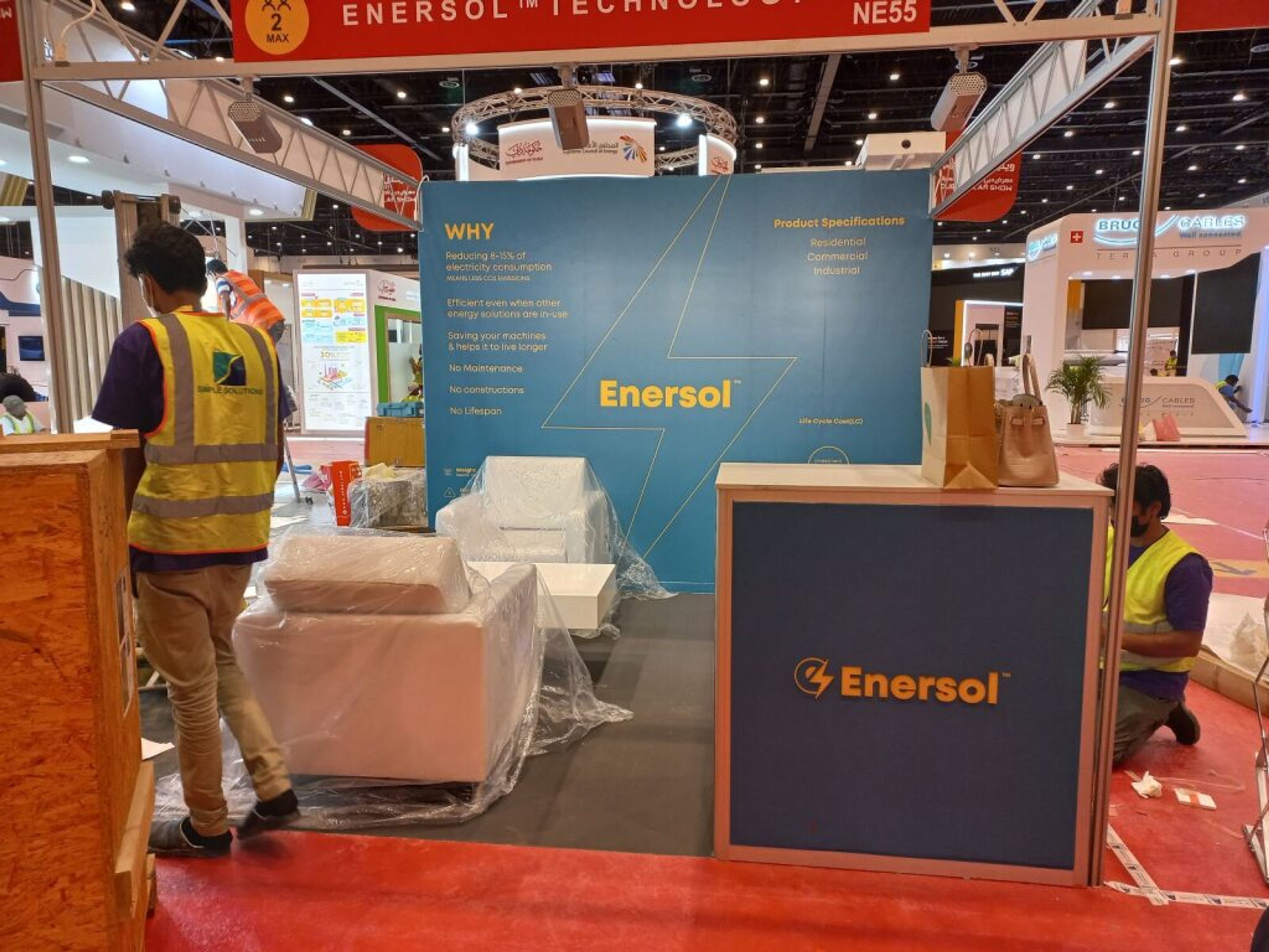 Exhibition stand under construction with crew in safety vests