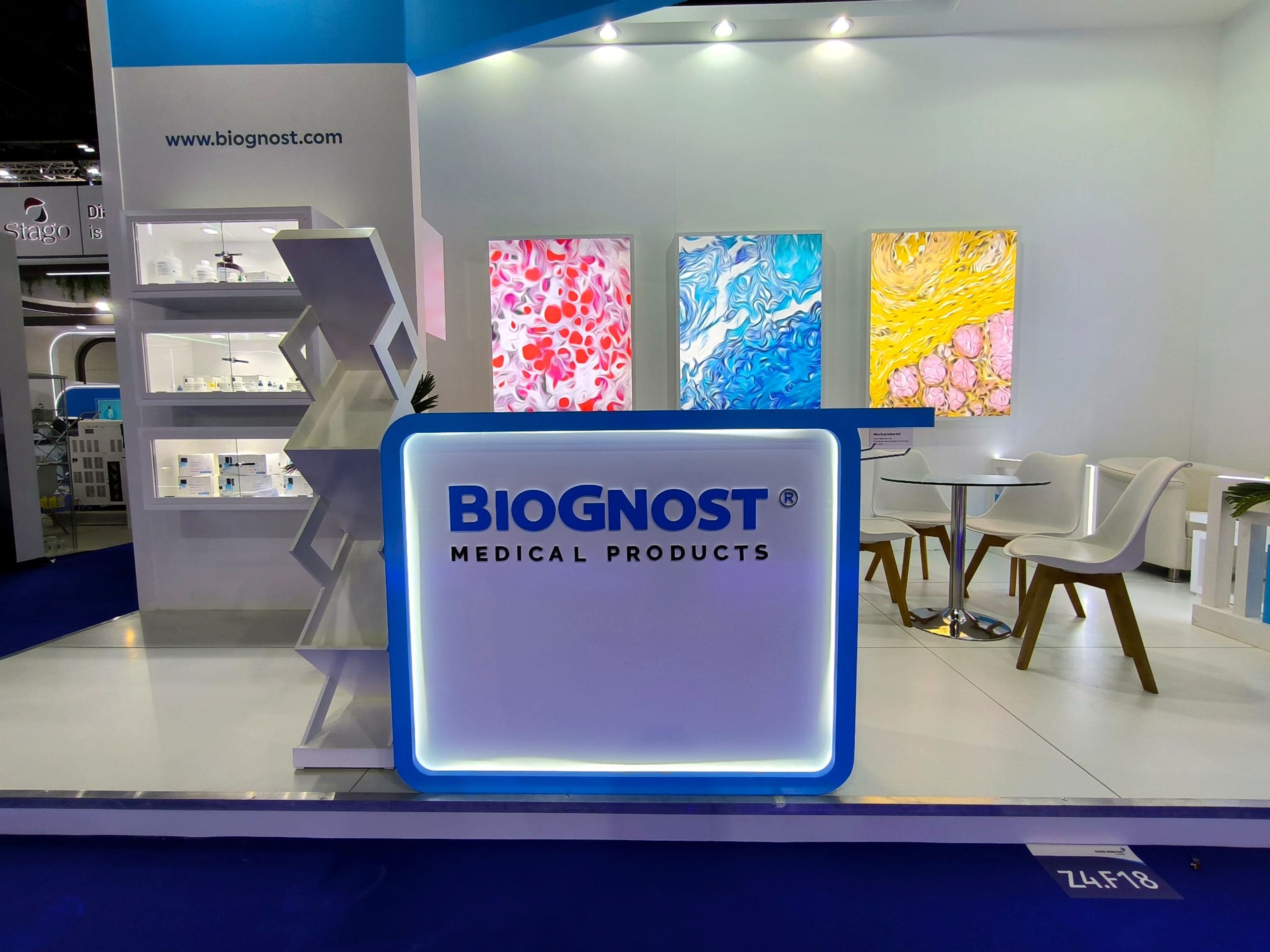 Biognost stand reception counter and backlit microscopy image panels at Medlab