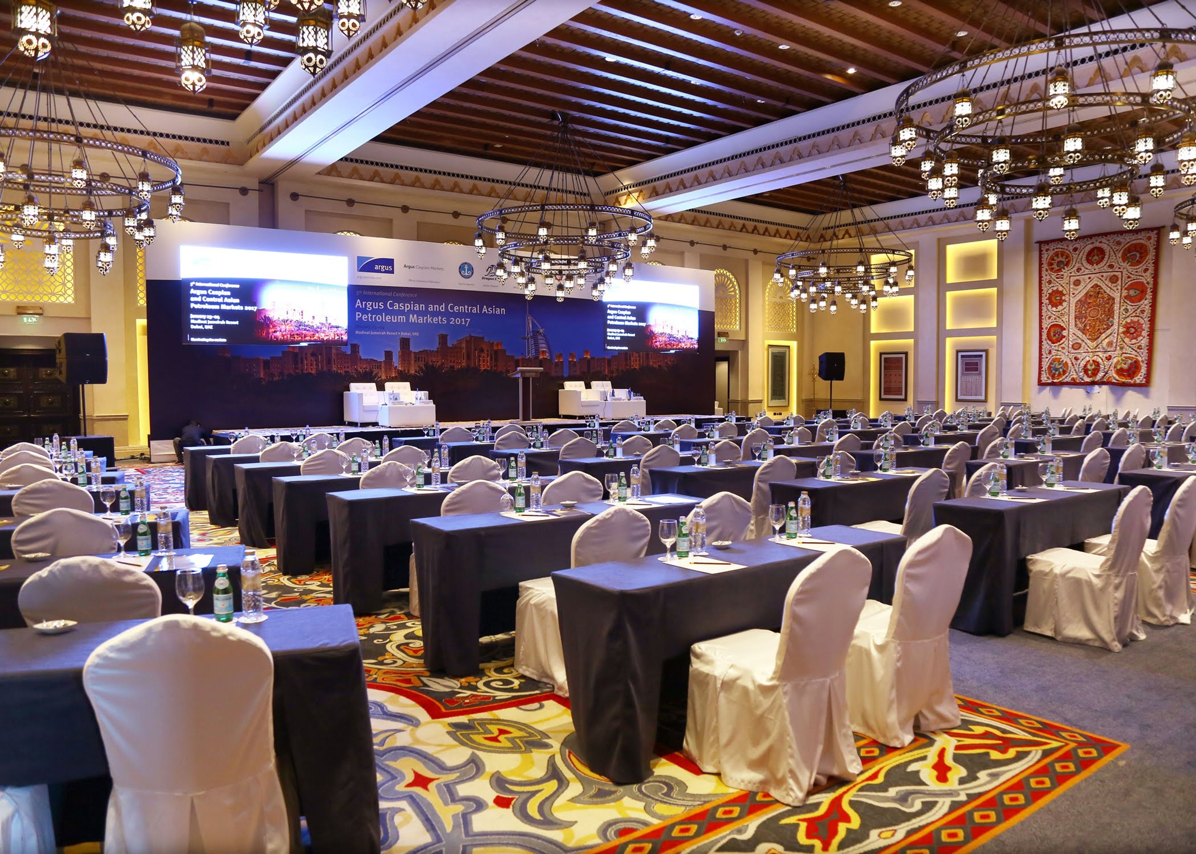 Ornate hall set with classroom tables for a corporate conference