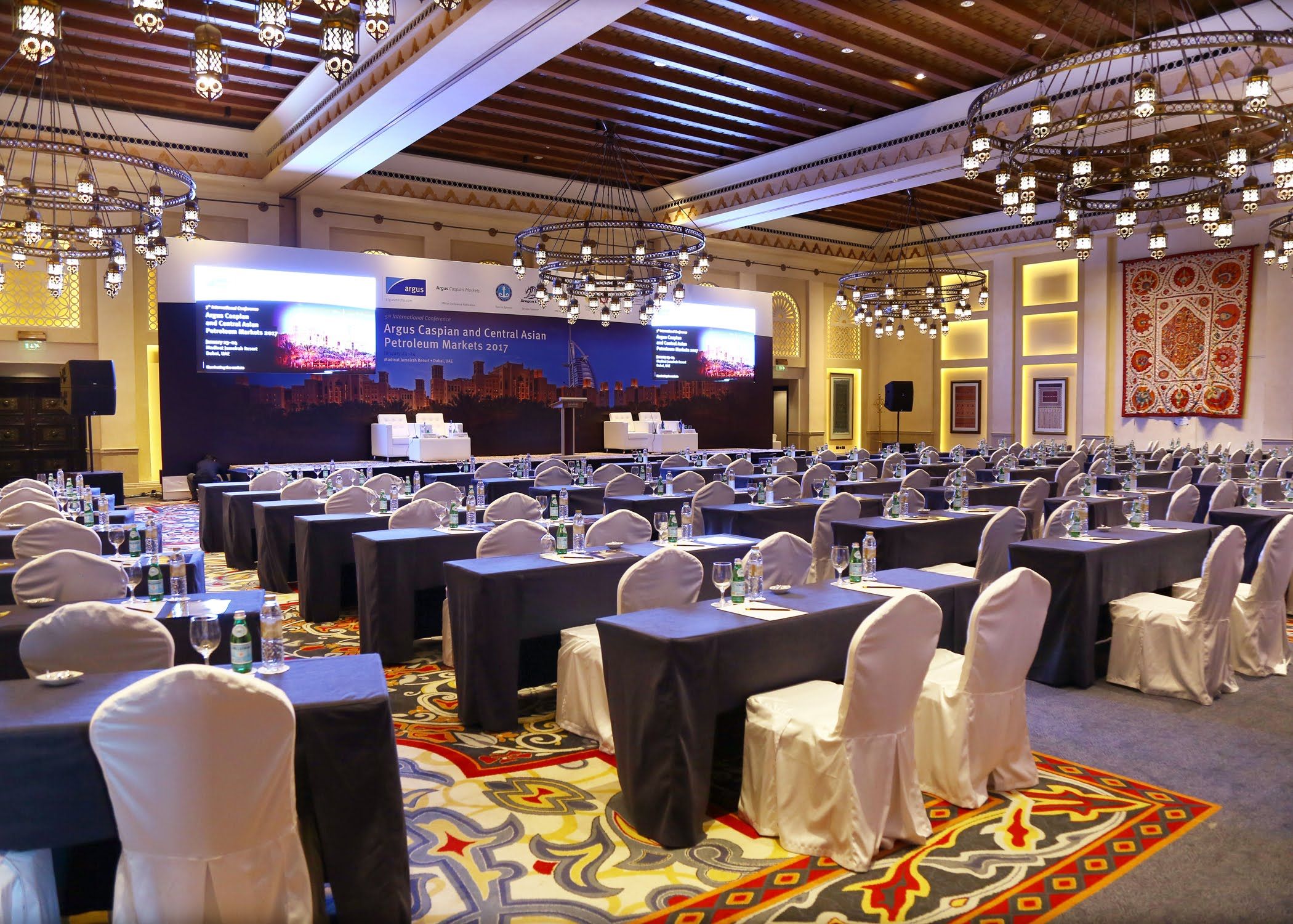 Ornate hall set with classroom tables for a corporate conference