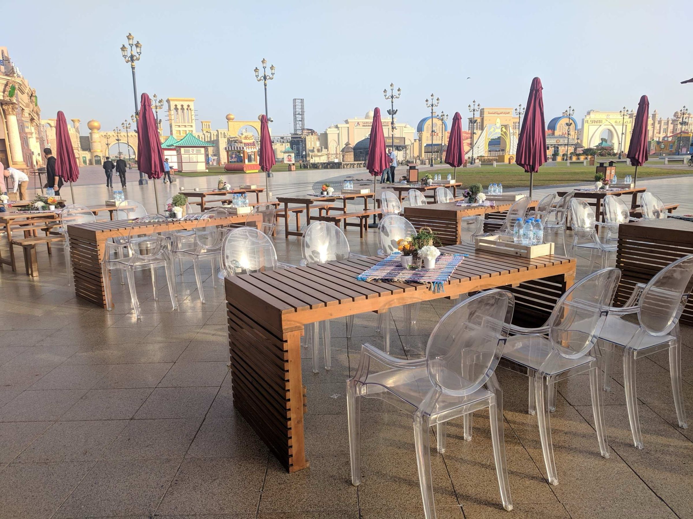 Waterfront terrace with tables and umbrellas set up for an outdoor event