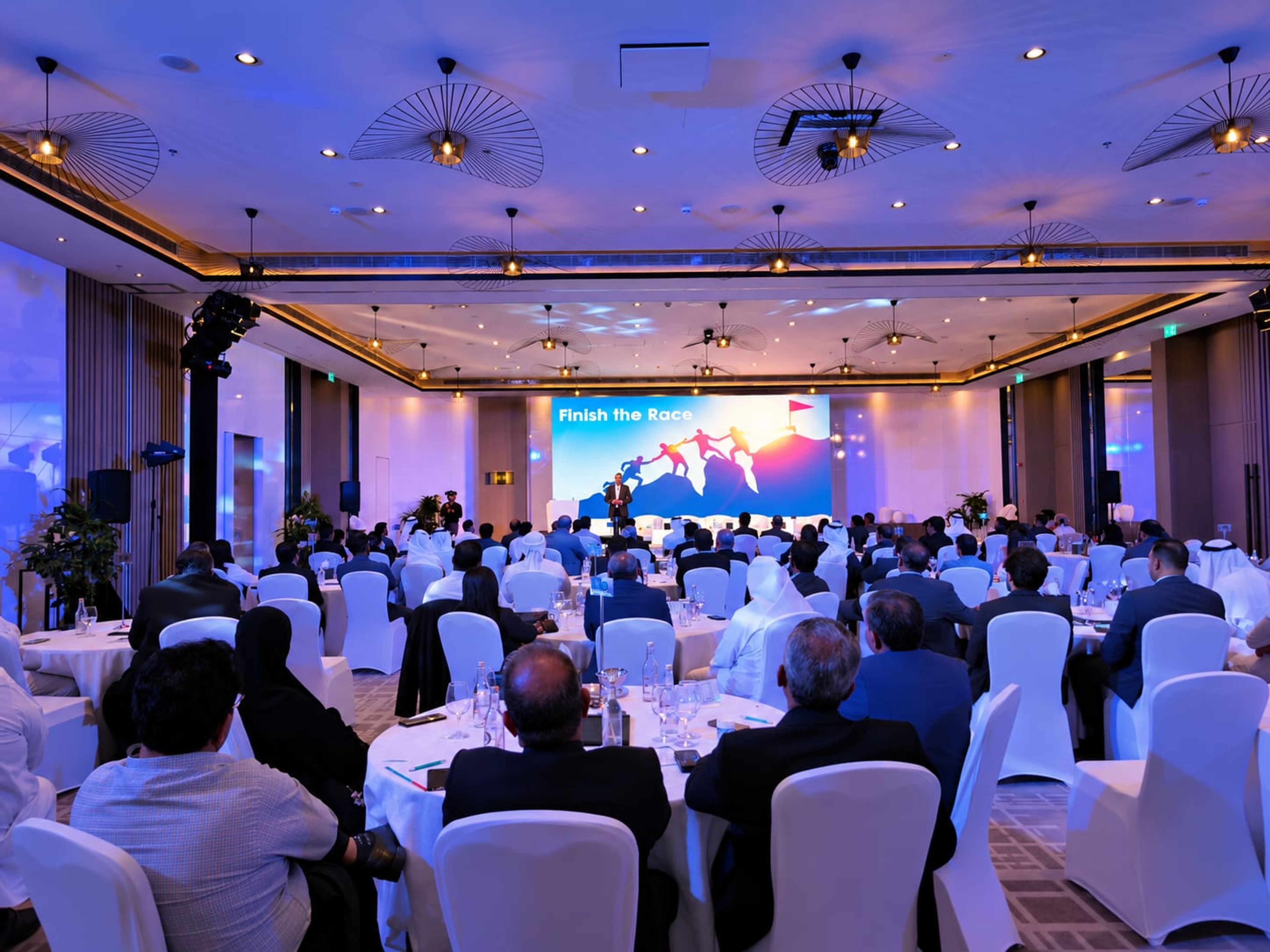 Al-Futtaim Logistics staff at round tables facing the LED screen at the 2024 GCC annual conference, Le Meridien JBR, Dubai