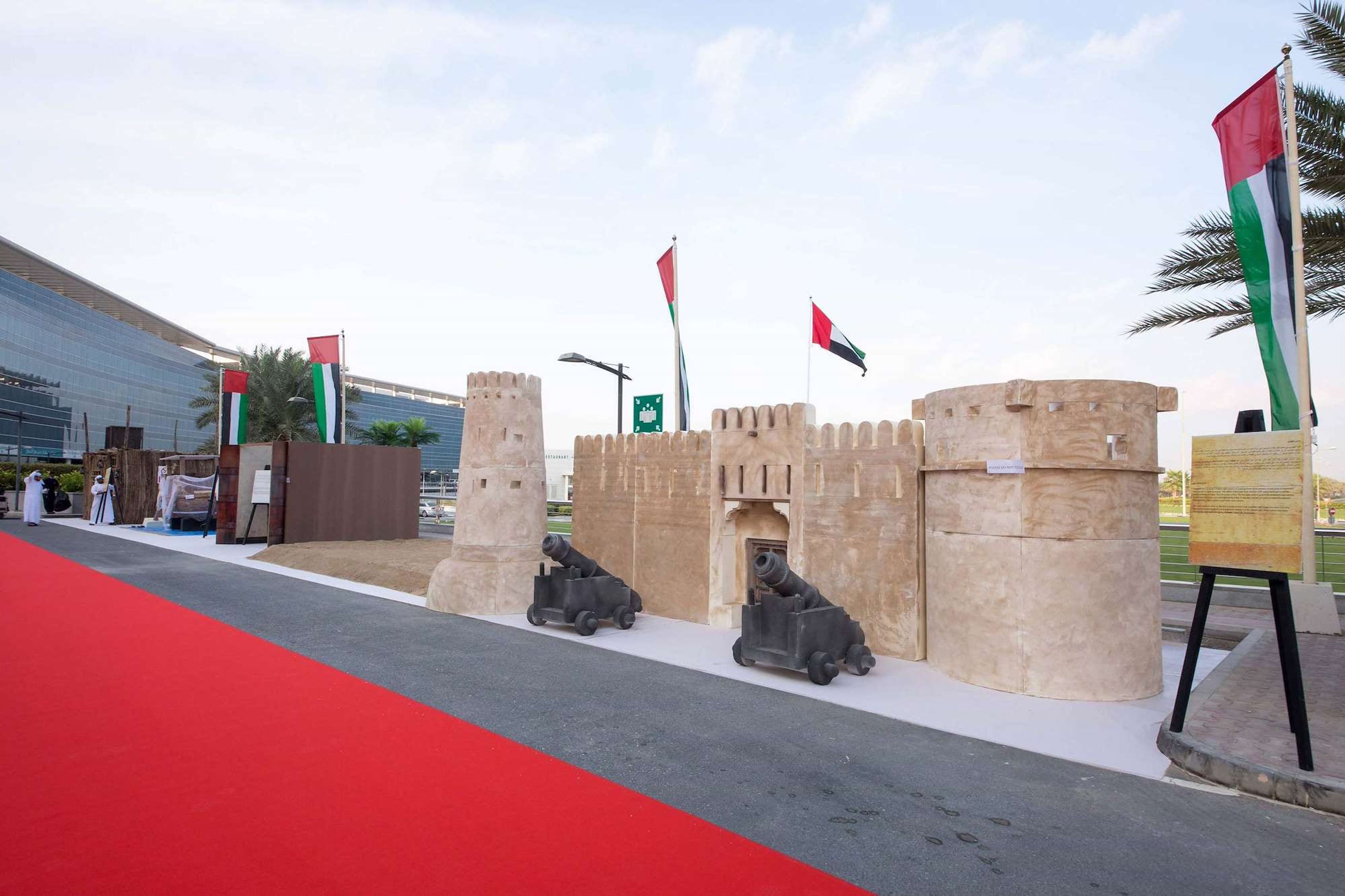 Fort replica with cannons and UAE flags at the Dubai South National Day heritage village