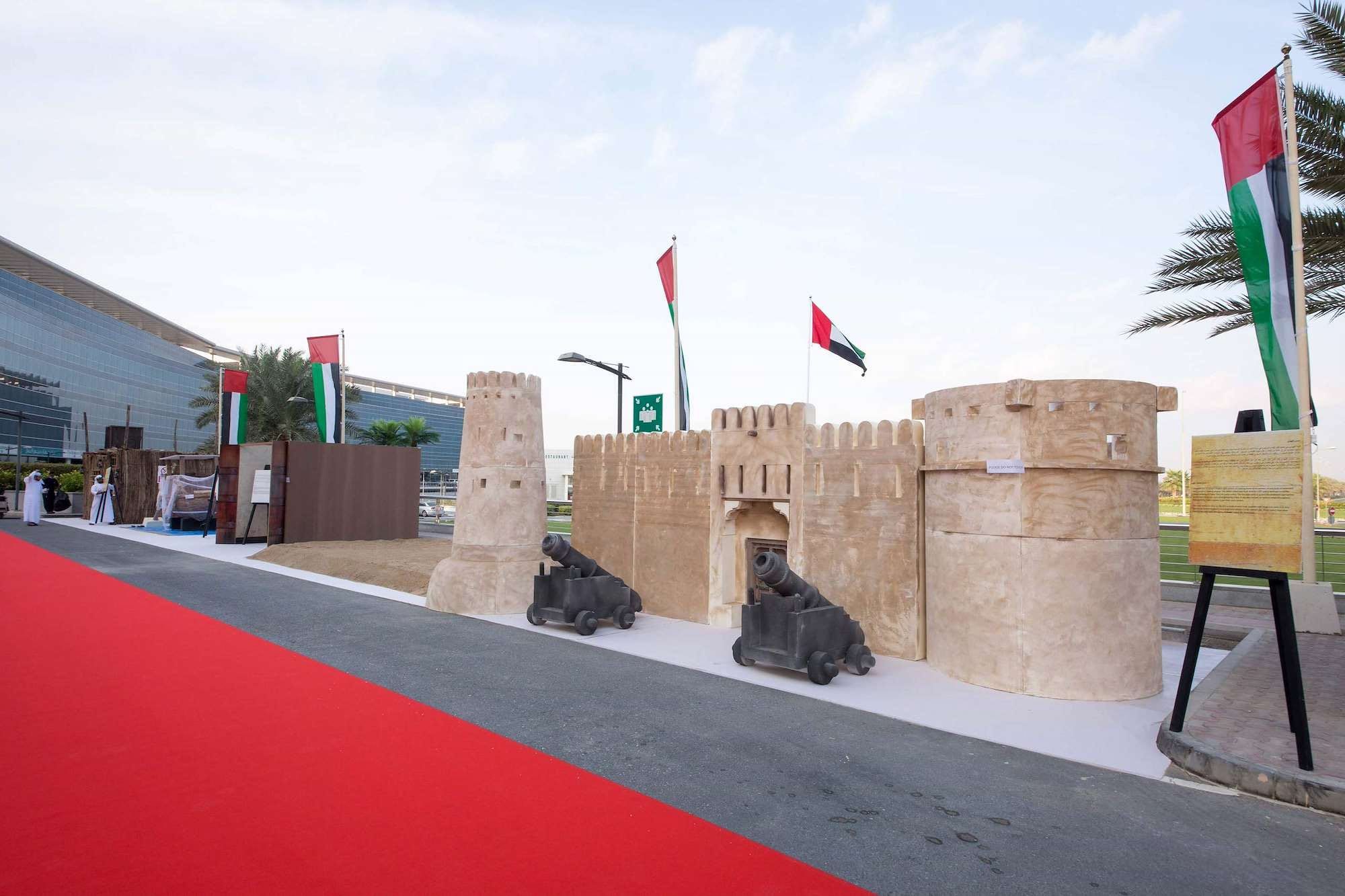 Fort replica with cannons and UAE flags at the Dubai South National Day heritage village