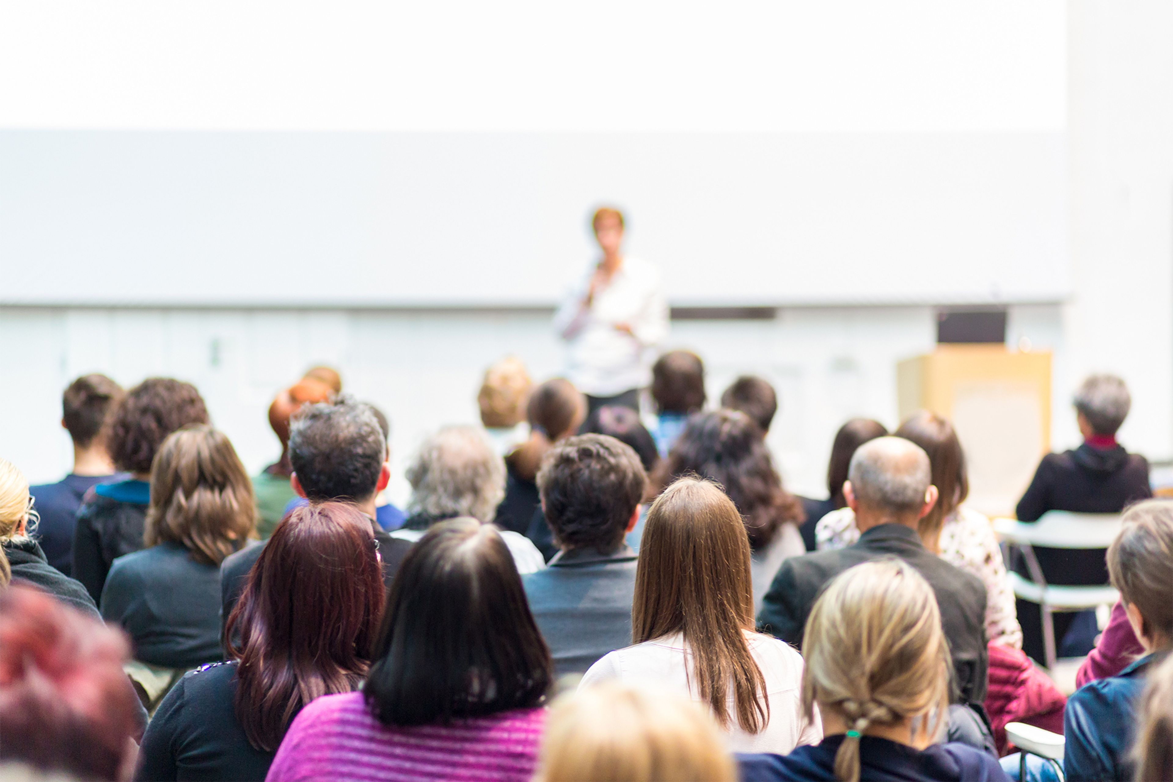 Audience listening to a speaker at a wellness workshop