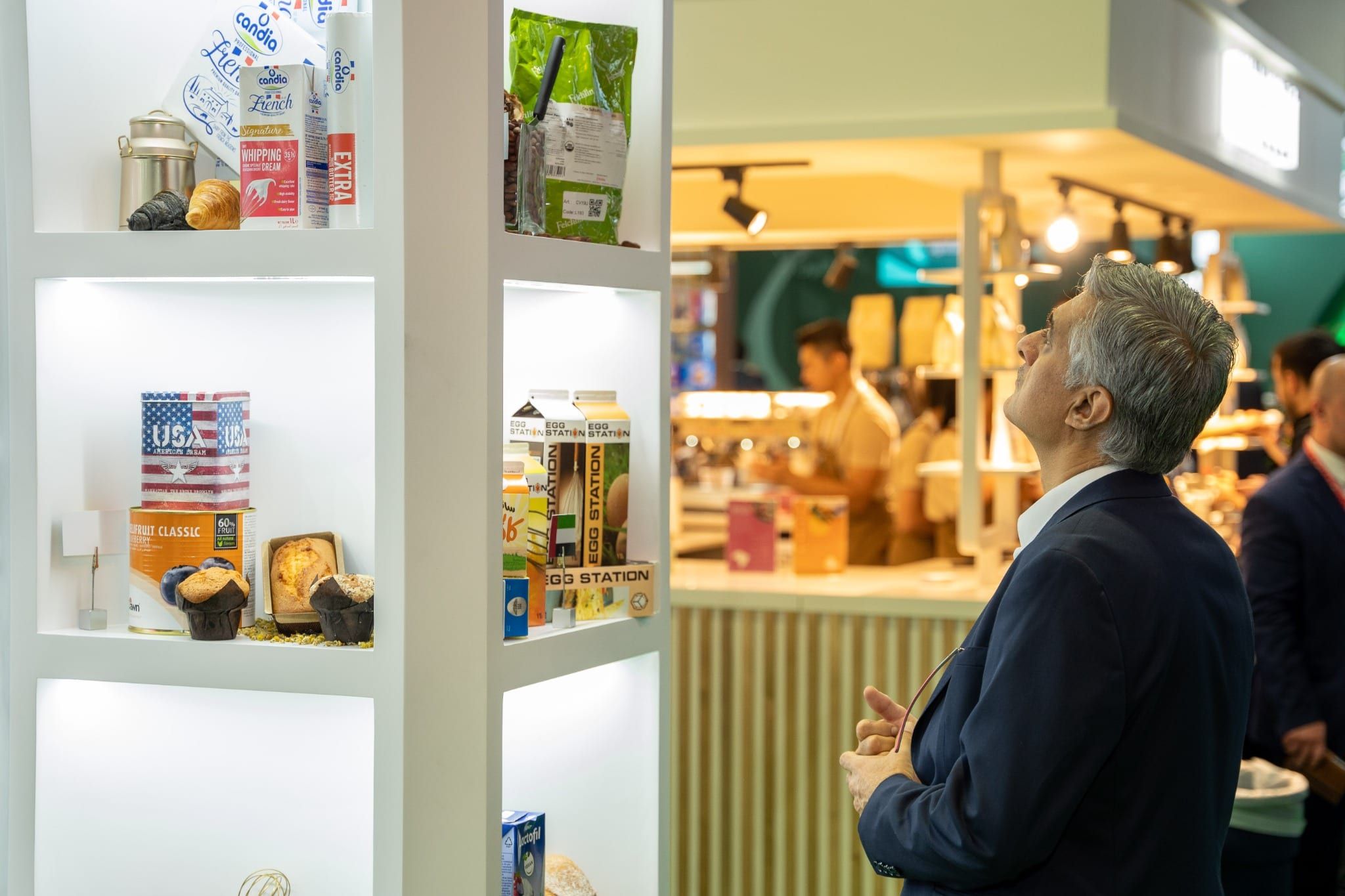 Visitor viewing food product displays on the Switz Group stand at Gulfood