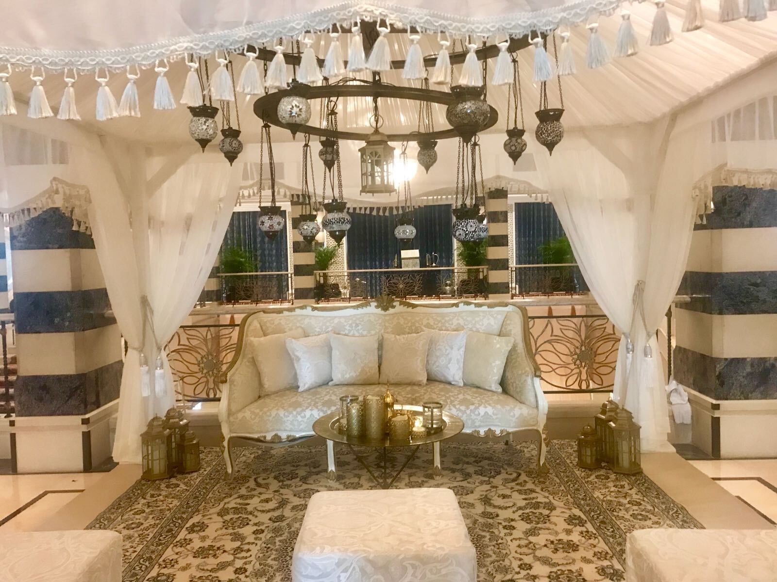 Luxury majlis lounge with cream sofas and a chandelier