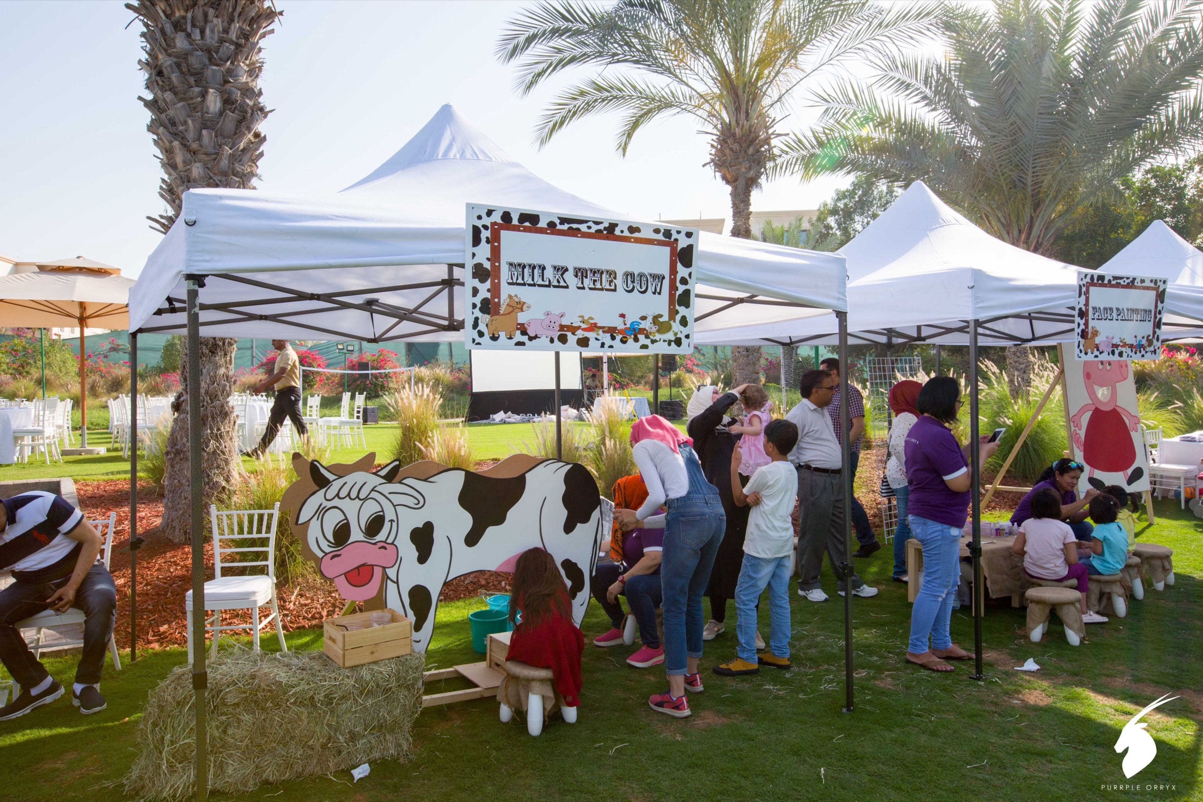 Families visiting stalls at an outdoor community fair