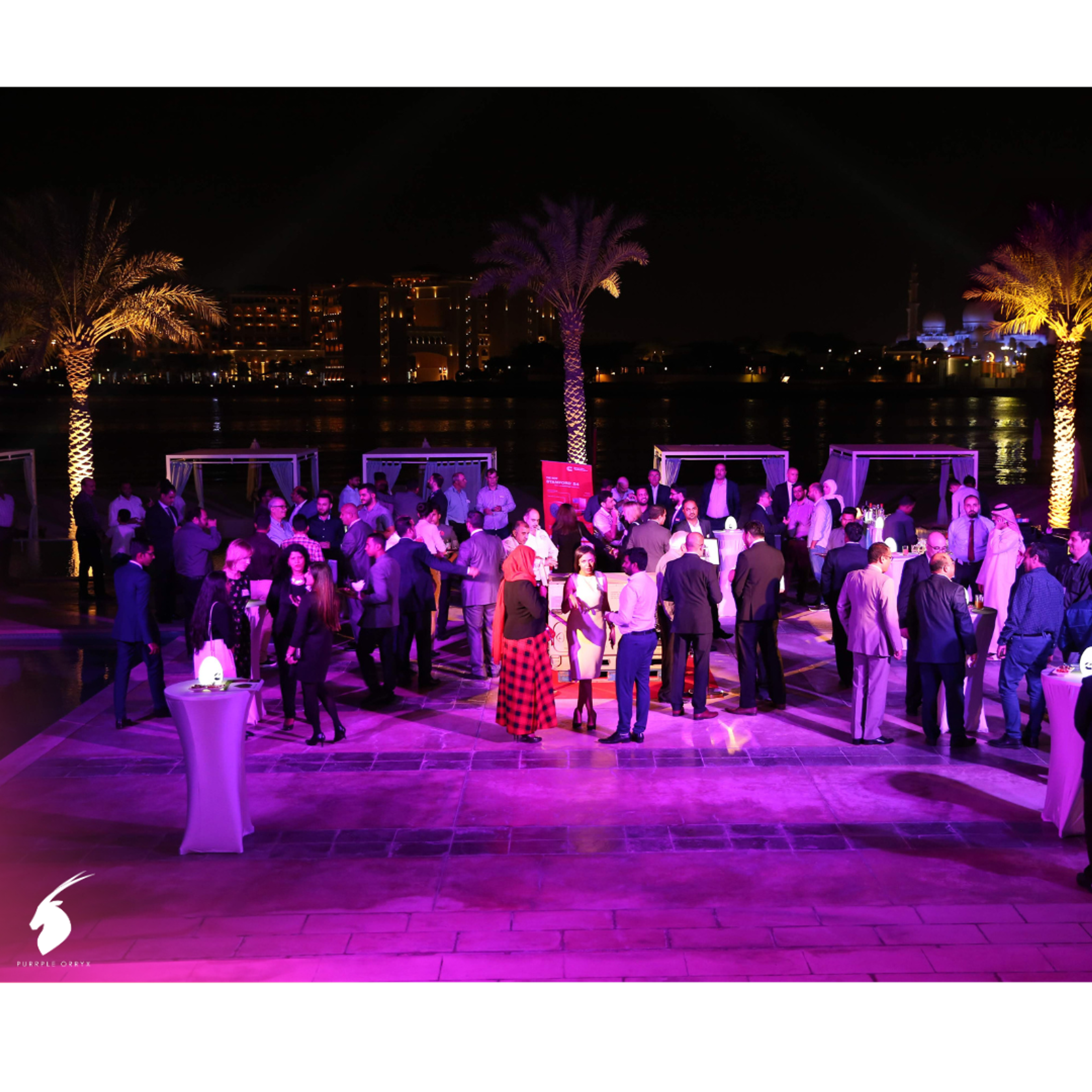 Guests dancing at an outdoor evening corporate party