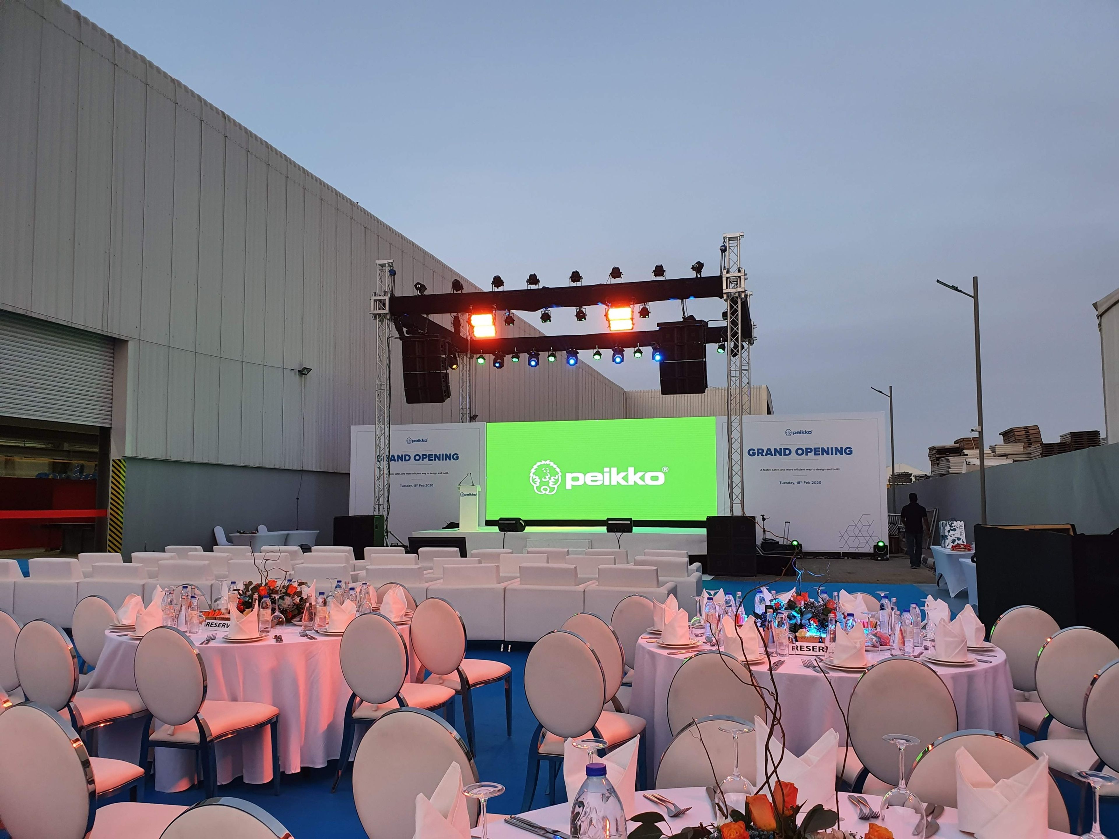 Dynamic LED screens showcasing vibrant visuals at a corporate event, reducing custom material waste with sustainable technology